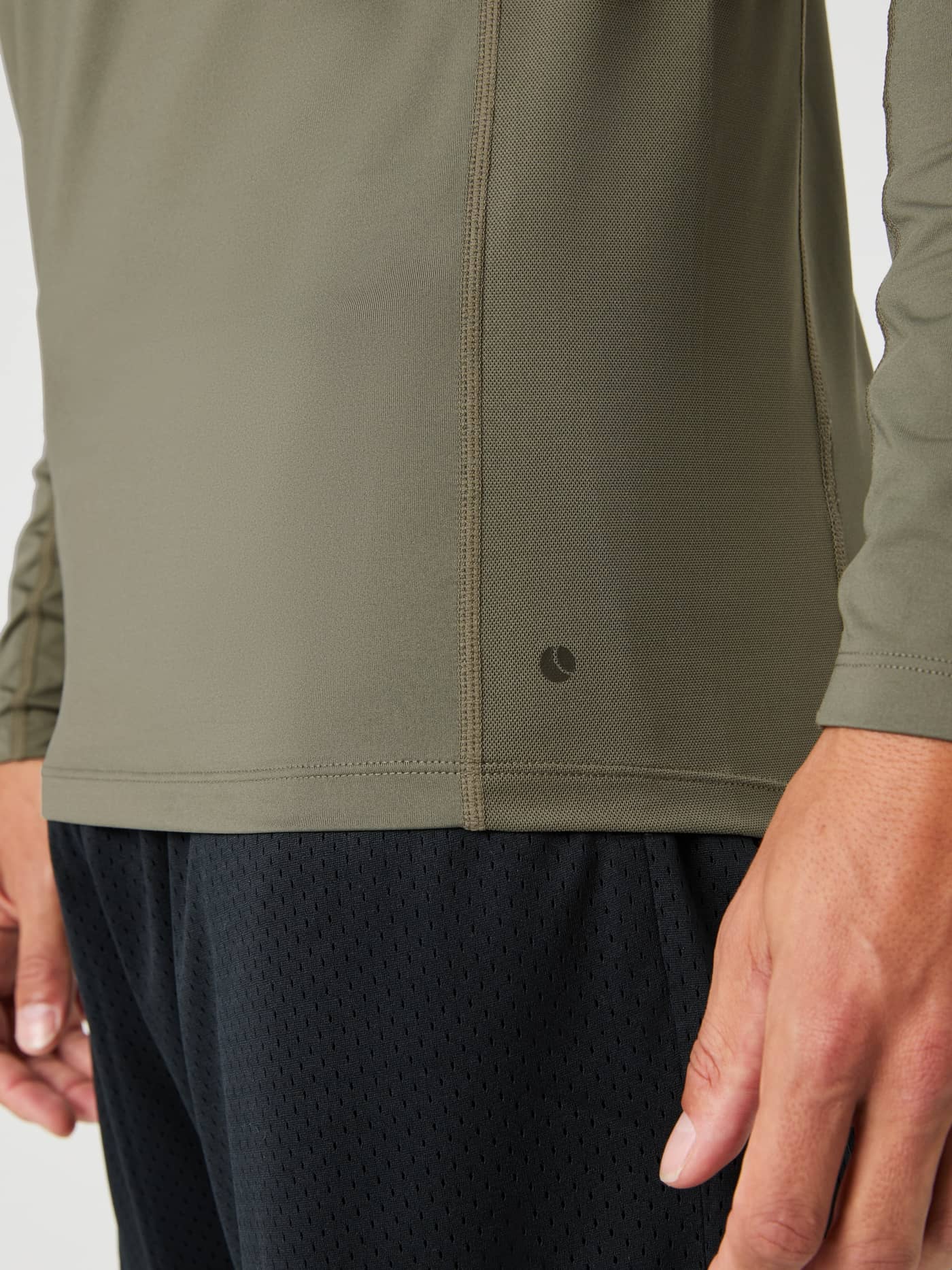 Close-up side view of the Borg Mock Neck Long Sleeve T-shirt in dusty olive, showing the breathable mesh panel and hem logo. - Image 5