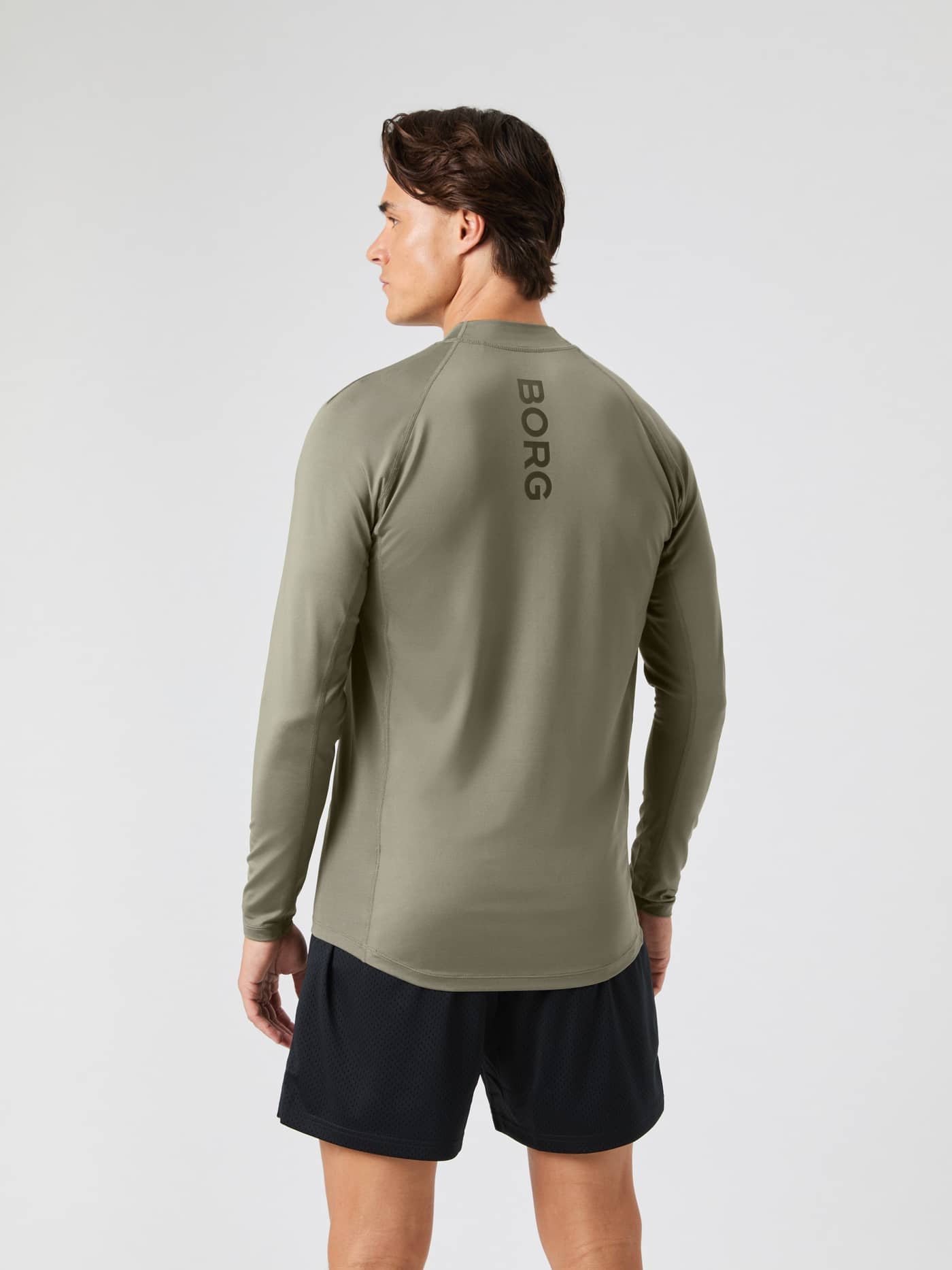 Back view of a man wearing the dusty olive Borg Mock Neck Long Sleeve T-shirt. - Image 2