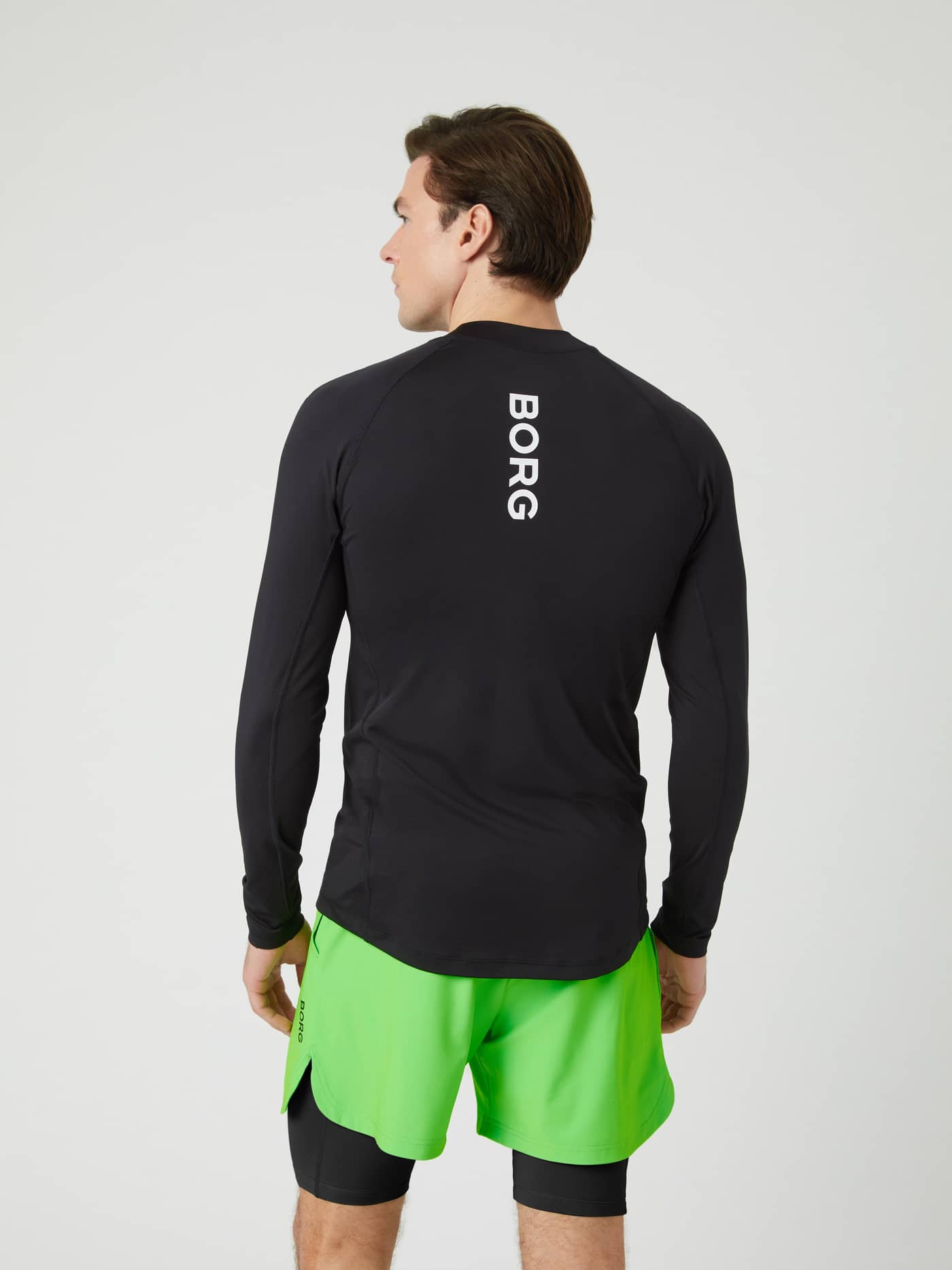 Back view of a model wearing the black Borg Mock Neck Long Sleeve T-shirt, showing the vertical BORG logo on the spine. - Image 4