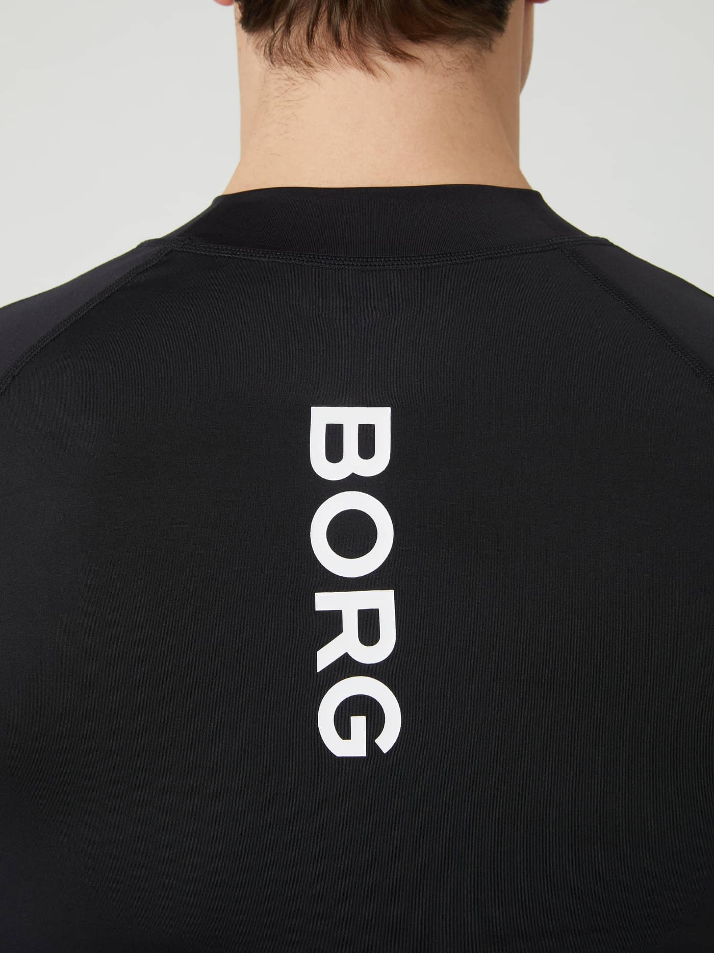 Close-up of the back of the black Borg Mock Neck Long Sleeve T-shirt, highlighting the vertical BORG logo print. - Image 2