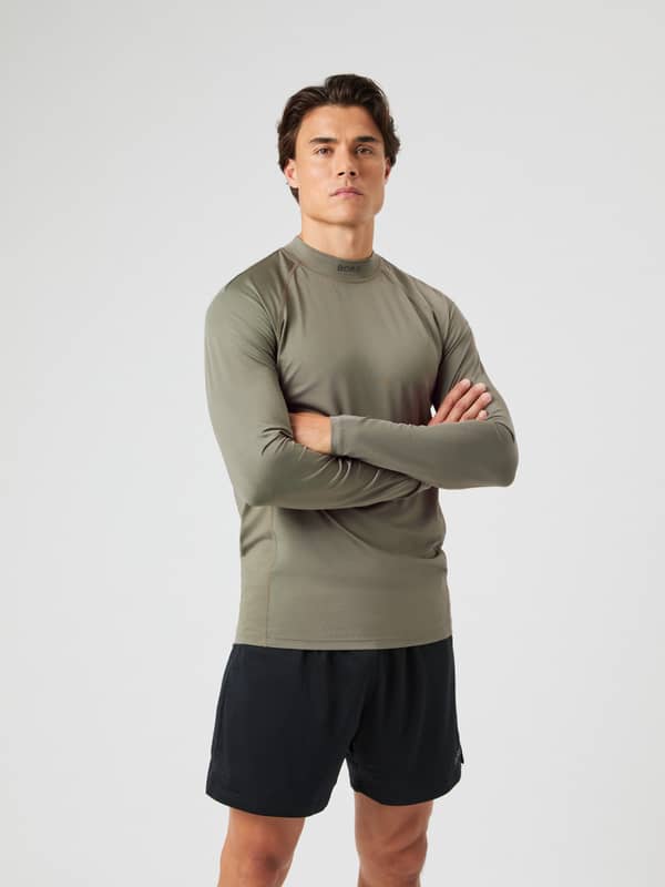 Front view of a model wearing the Björn Borg Mock Neck LS T-shirt in Dusty Olive.