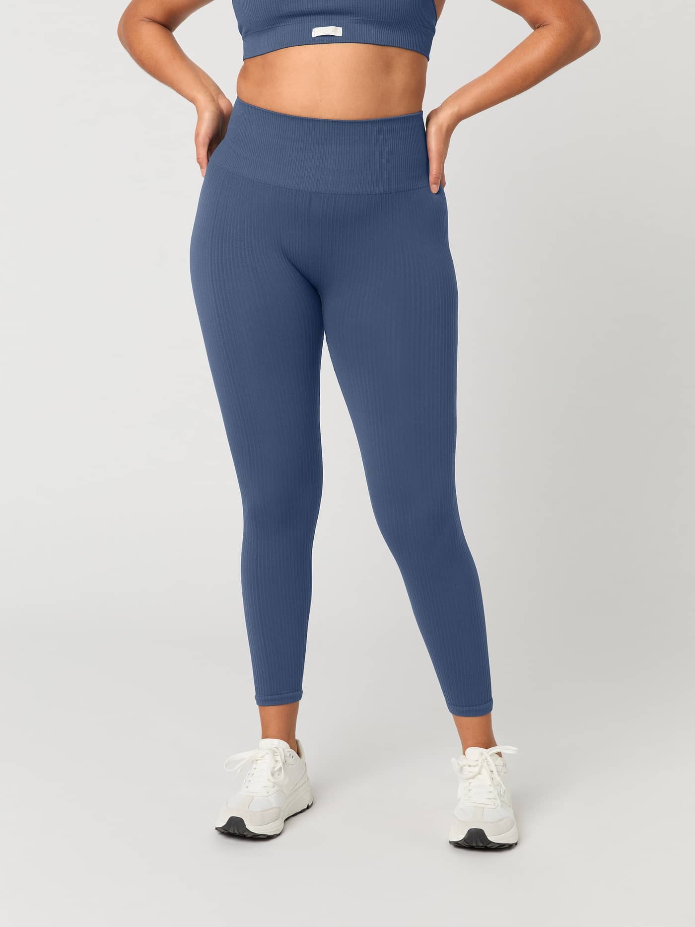 Close-up front view of a model wearing the Björn Borg Studio Seamless Ribbed Tights in Nightshadow Blue. - Image 2