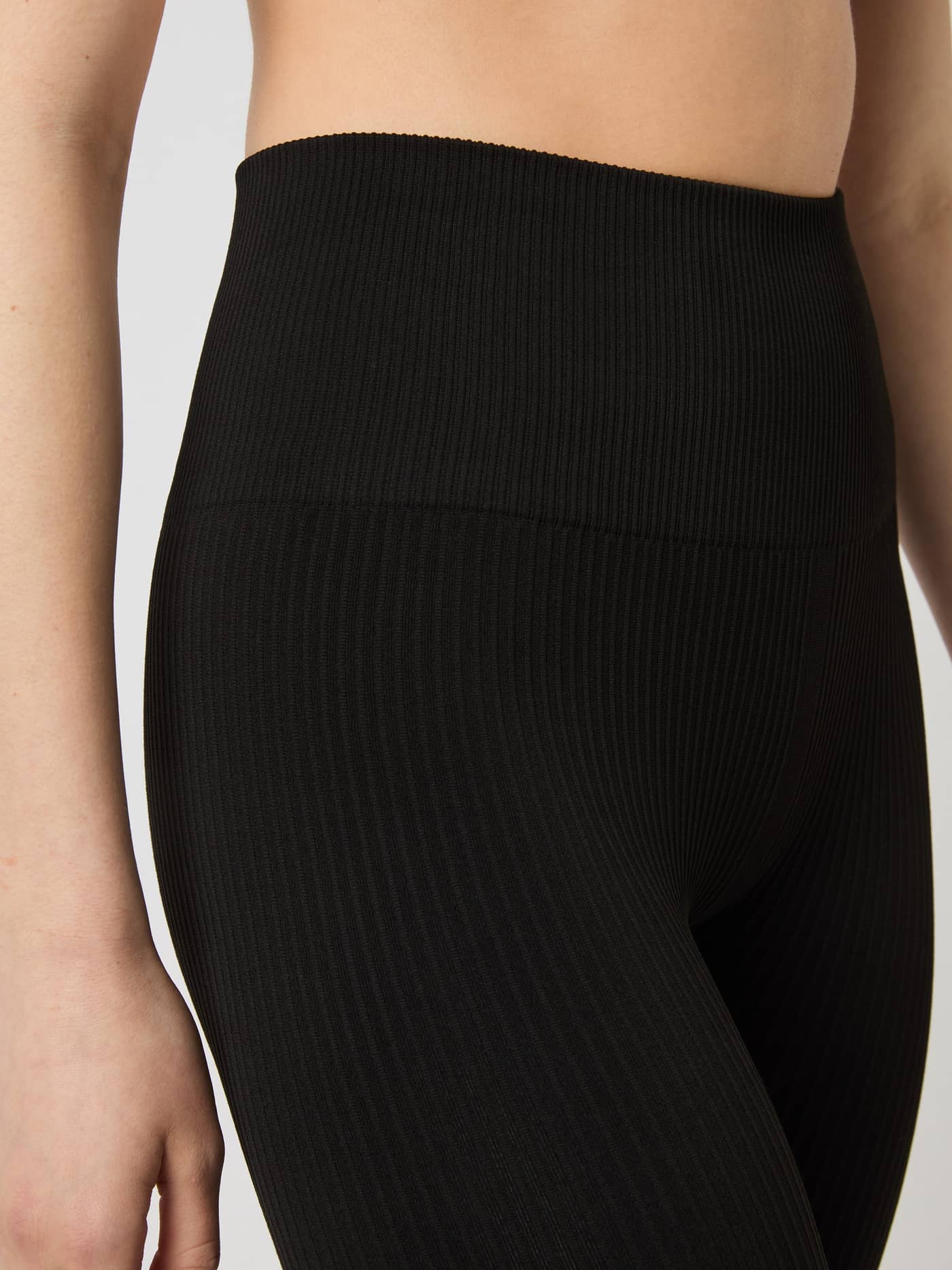 Close-up shot of the high, ribbed waistband on the black Björn Borg Studio Seamless Ribbed Tights. - Image 5