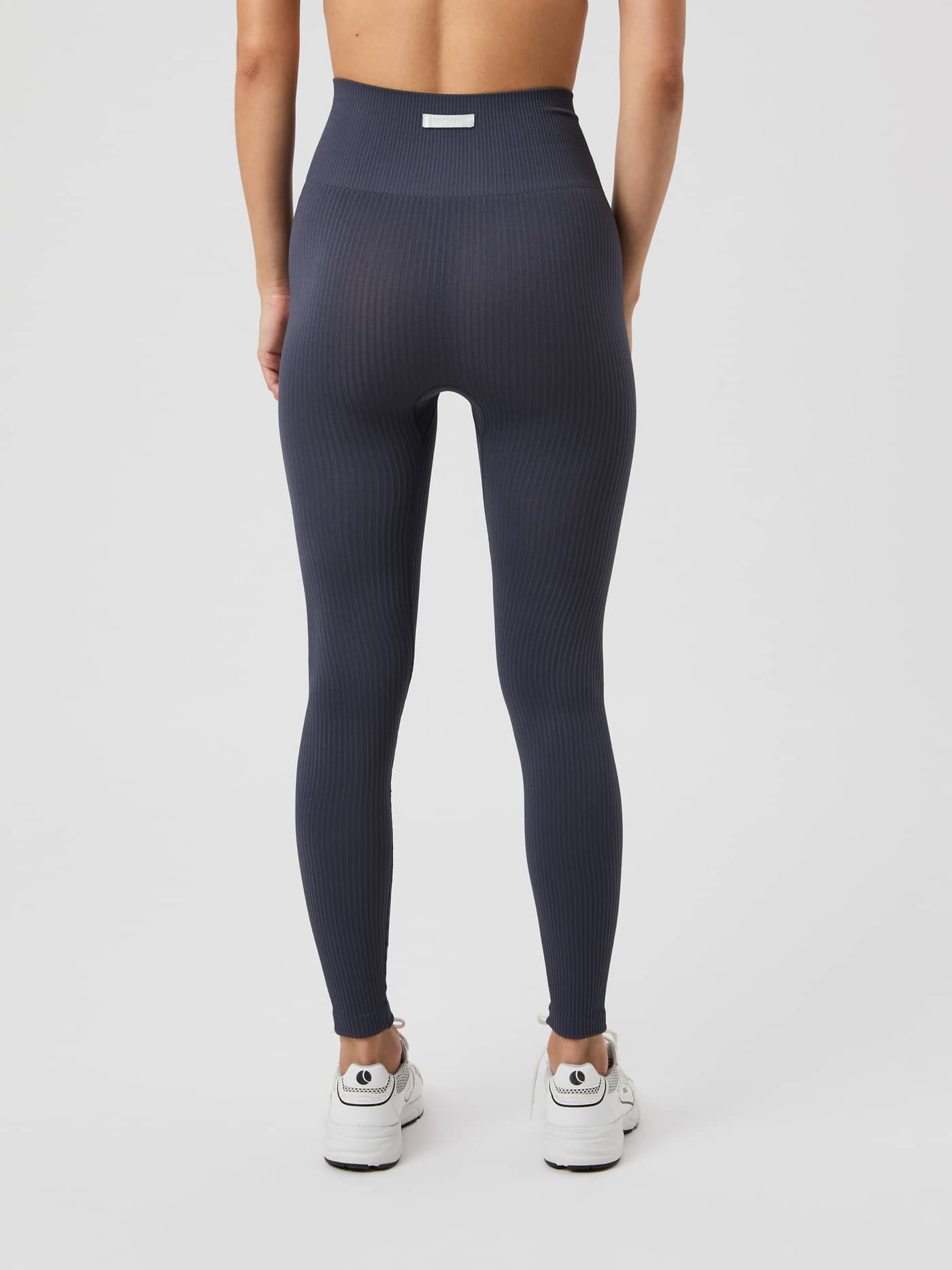 Björn Borg Studio Seamless Ribbed Tights in Odyssey Gray, seen from the back on a model. - Image 3