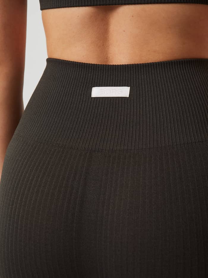 Detail shot of the Björn Borg logo on the back waistband of the peat Studio Seamless Ribbed Tights.