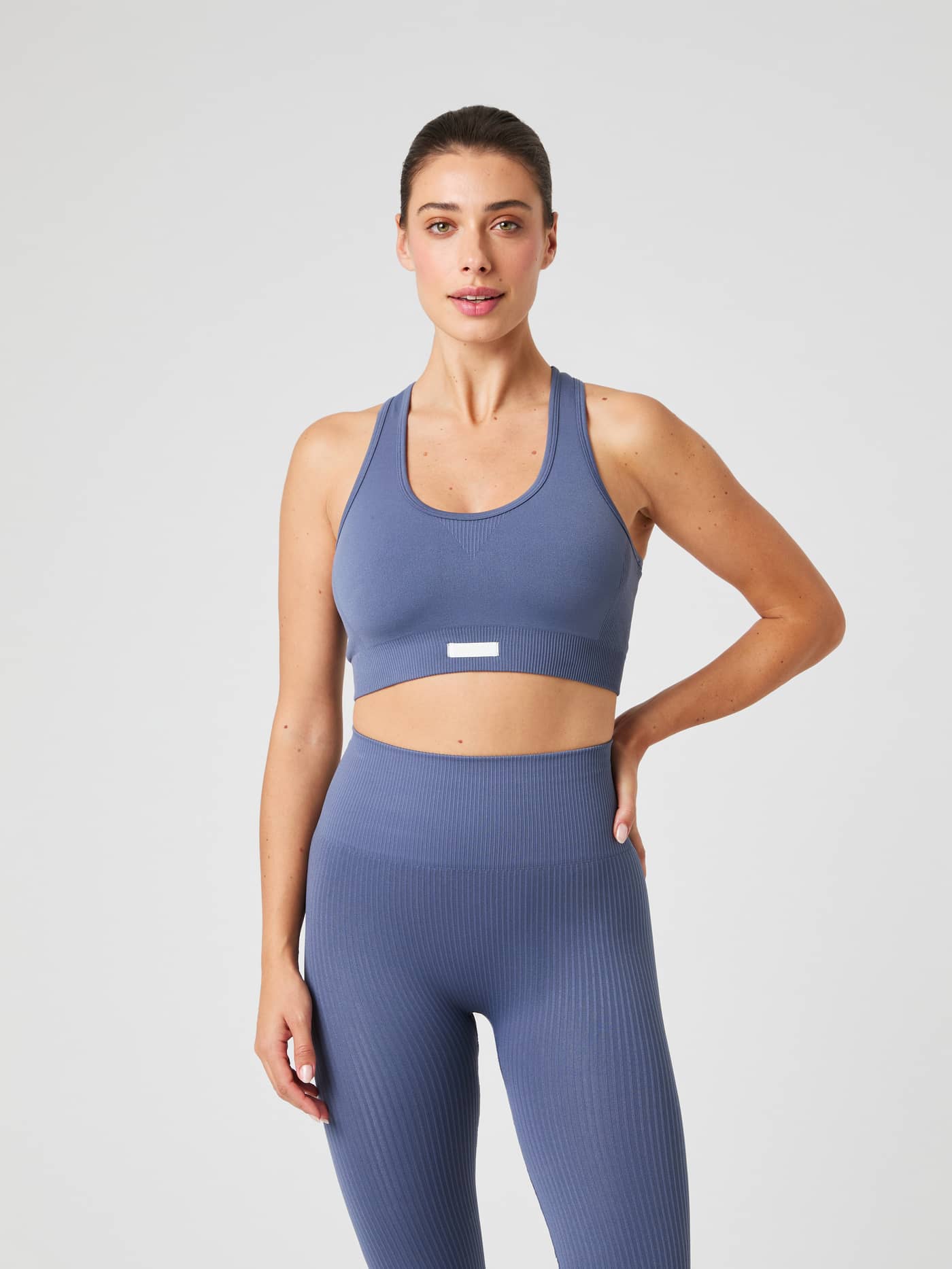 Front view of a model wearing the Björn Borg Studio Seamless Low Sports Bra in Nightshadow Blue. - Image 1