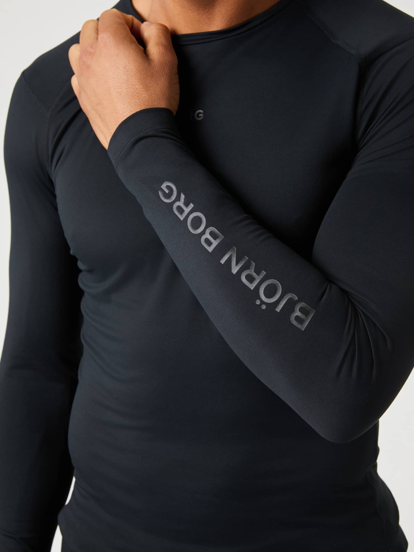 Close-up of the training Borg Soft Compression Ls T-Shirt in Black Beauty (Black) with a tonal grey sleeve logo. - Image 5