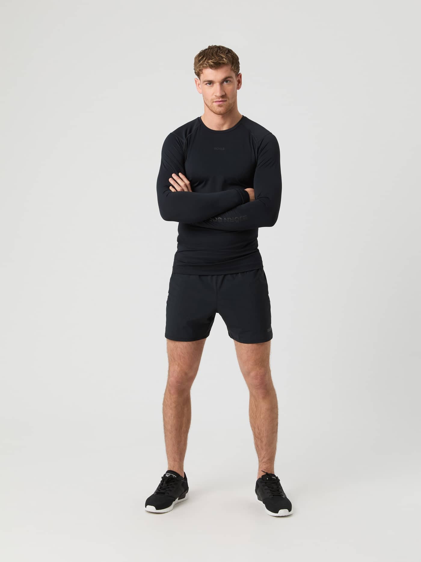 Full-body front view of a man wearing the Borg Soft Compression Ls T-Shirt in Black Beauty (Black) for training. - Image 4