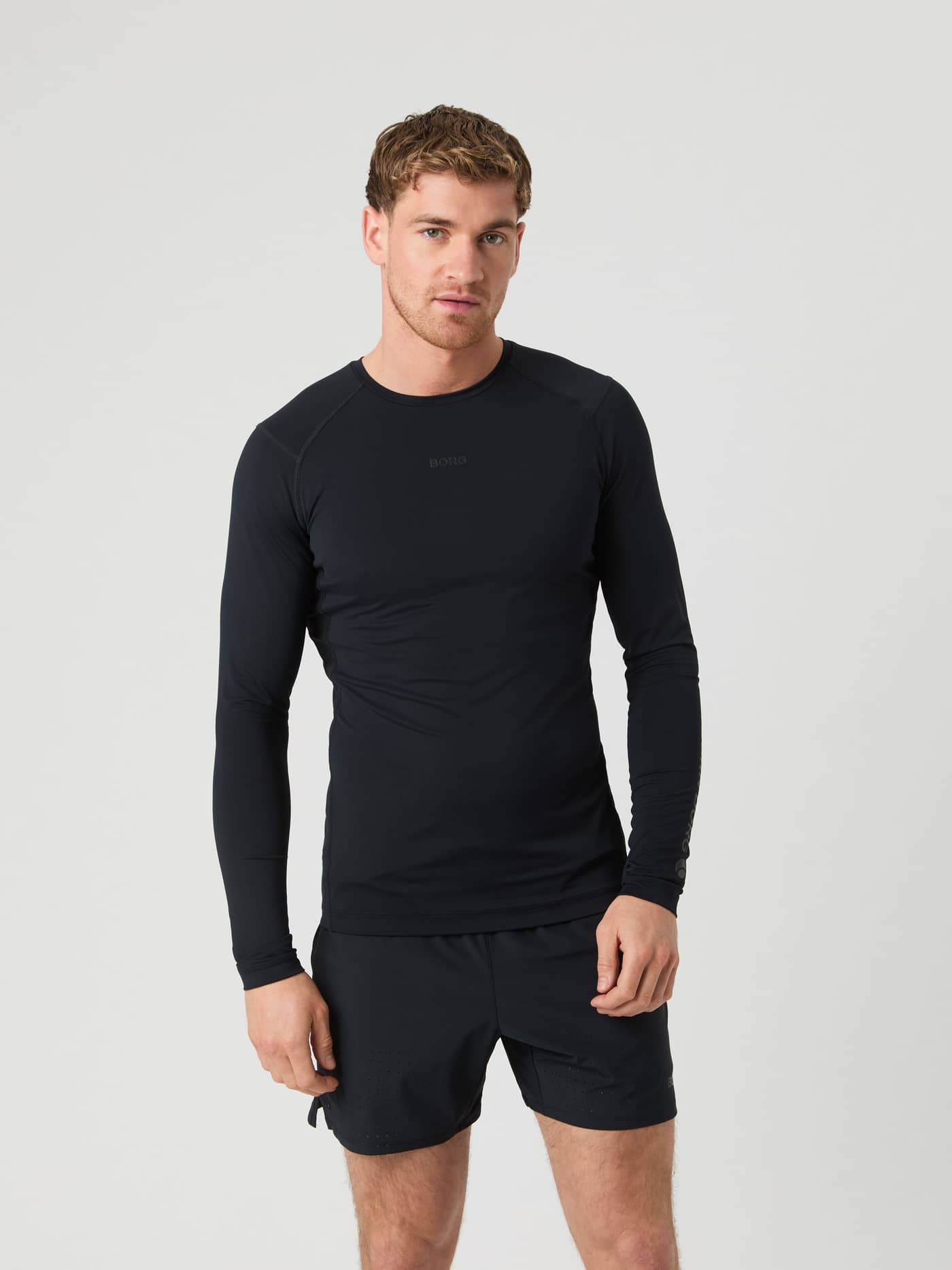 Front view of a man wearing the Borg Soft Compression Ls T-Shirt in Black Beauty (Black) for training performance. - Image 1