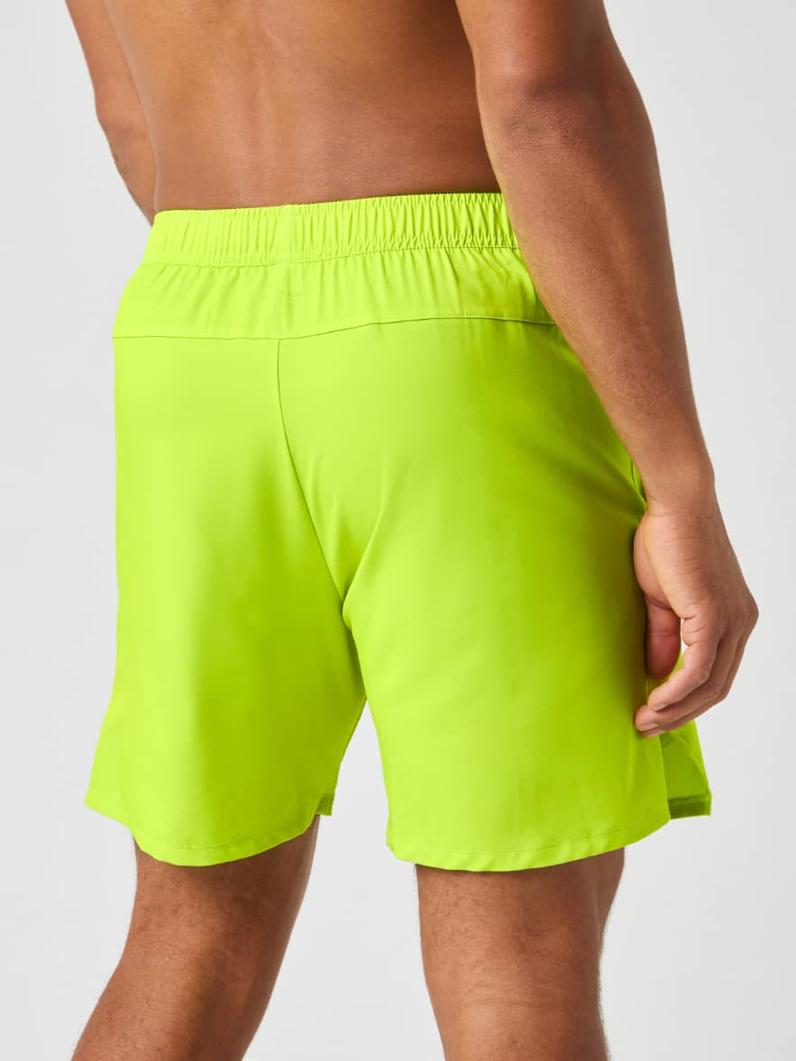 Back view of a model wearing the Björn Borg Ace Racquet Shorts 7 Inch in Acid Lime. - Image 3