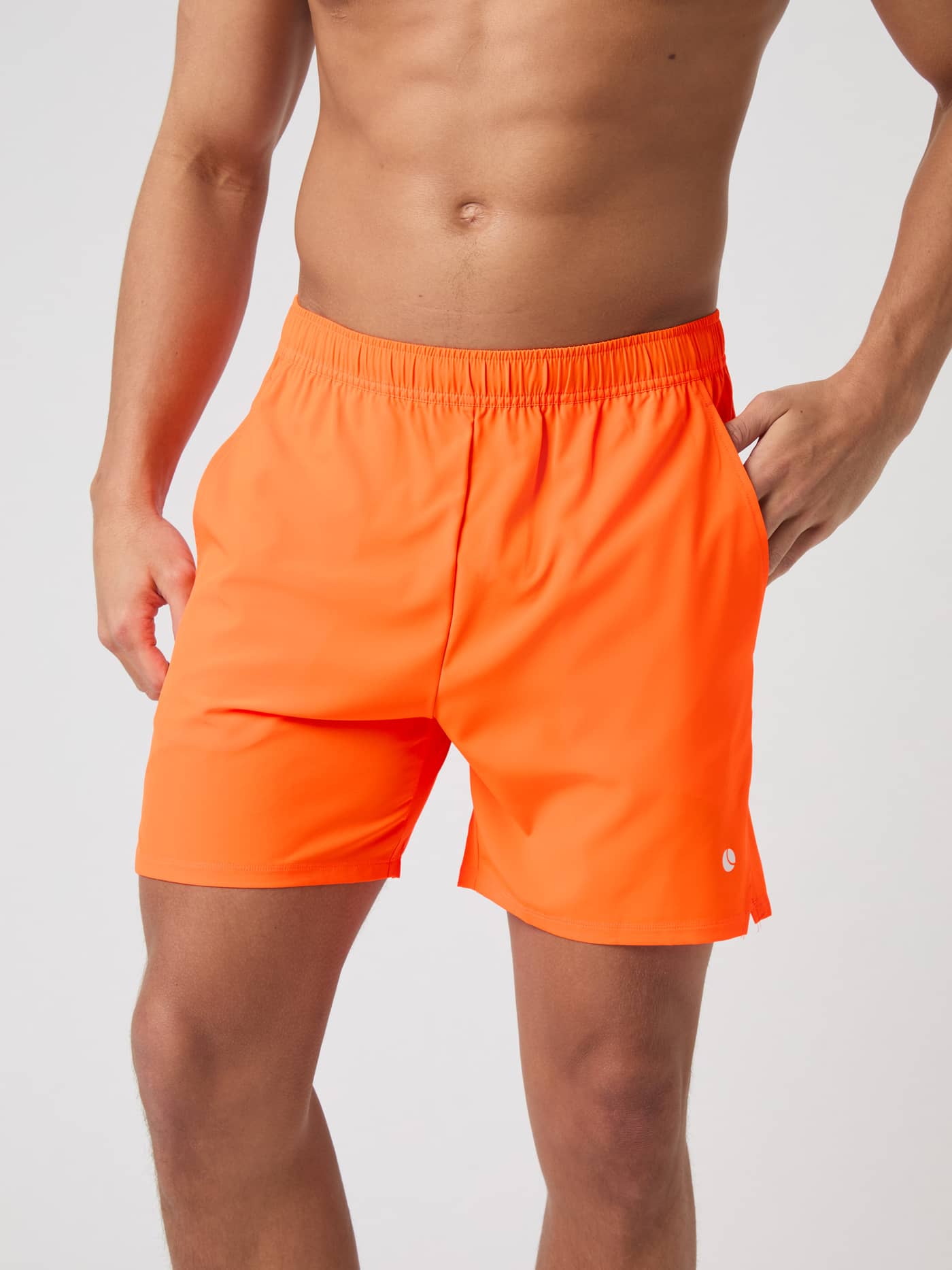 Front view of a model wearing Björn Borg Ace Racquet Shorts 7 Inch in Shocking Orange. - Image 1