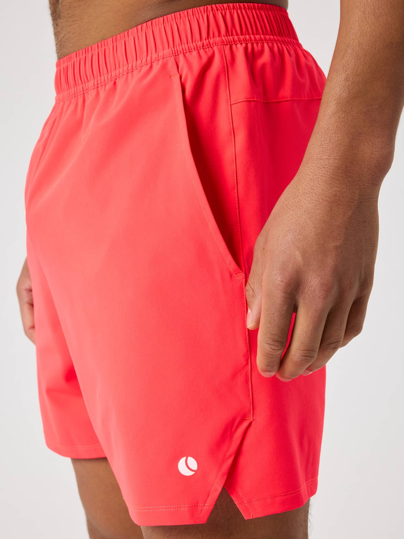 Side view of a model wearing the Björn Borg Ace Racquet Shorts 7 Inch in Diva Pink (Pink) with a white tennis ball logo. - Image 4