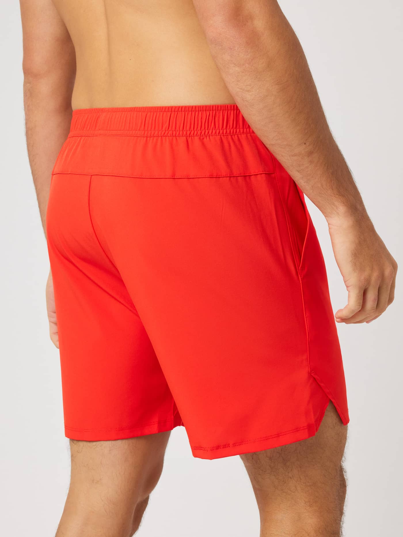 Back view of the Ace Racquet Shorts 7 Inch in Flame Scarlet (Red), featuring side slits for movement during tennis. - Image 2