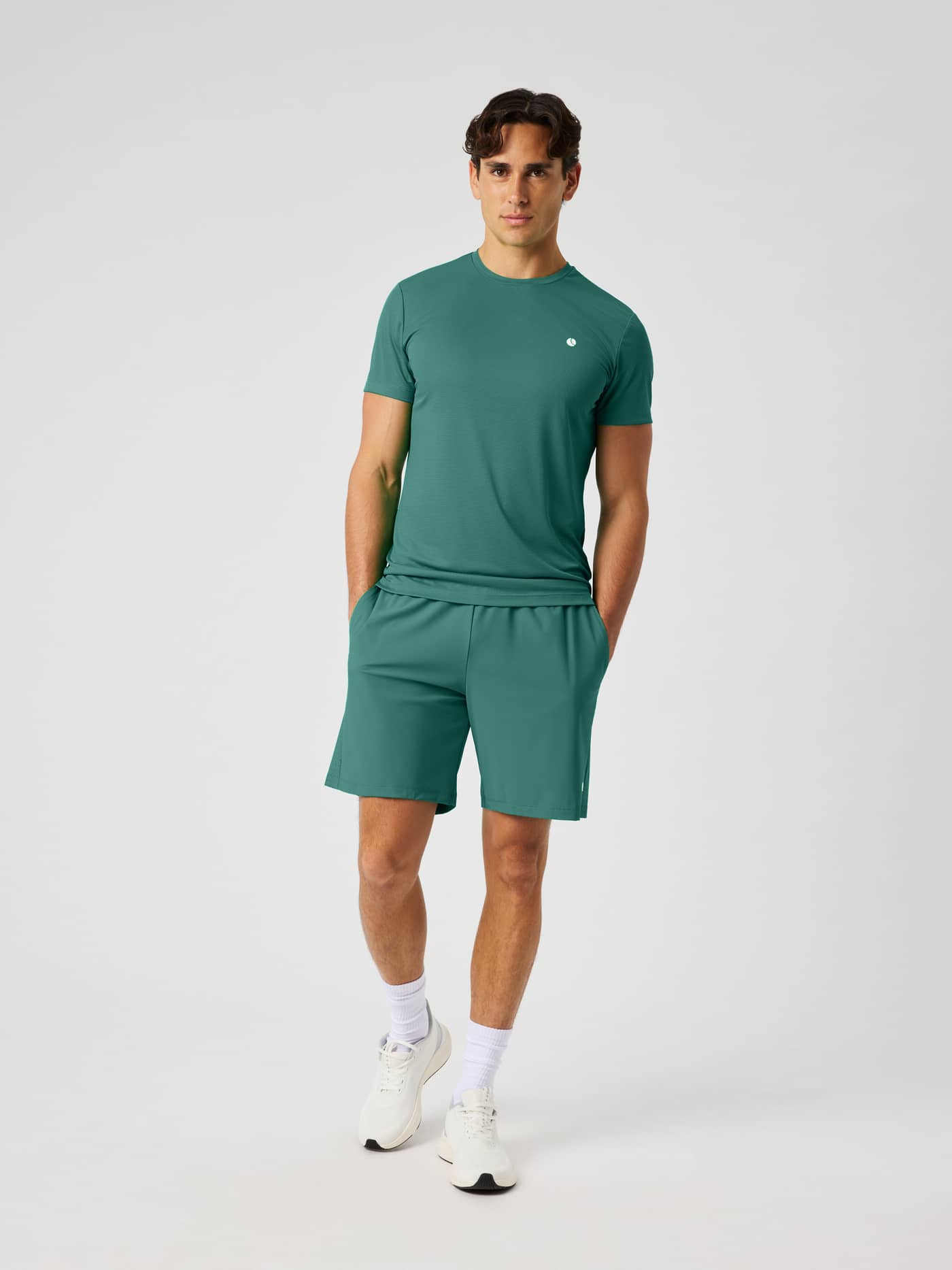 Full-body front view of a model wearing Ace Racquet Shorts 7 Inch in Mallard Green (Green) for tennis and padel. - Image 3