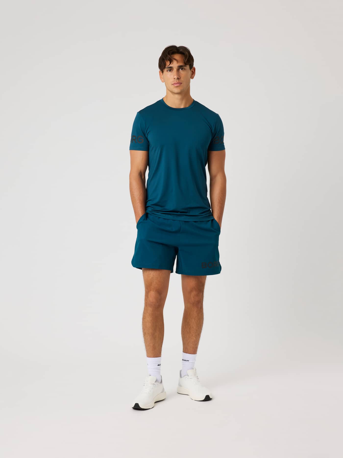 Full-body front view of a model wearing Ace Pro Shorts 7 Inch in Reflecting Pond (Green) for tennis and padel. - Image 3
