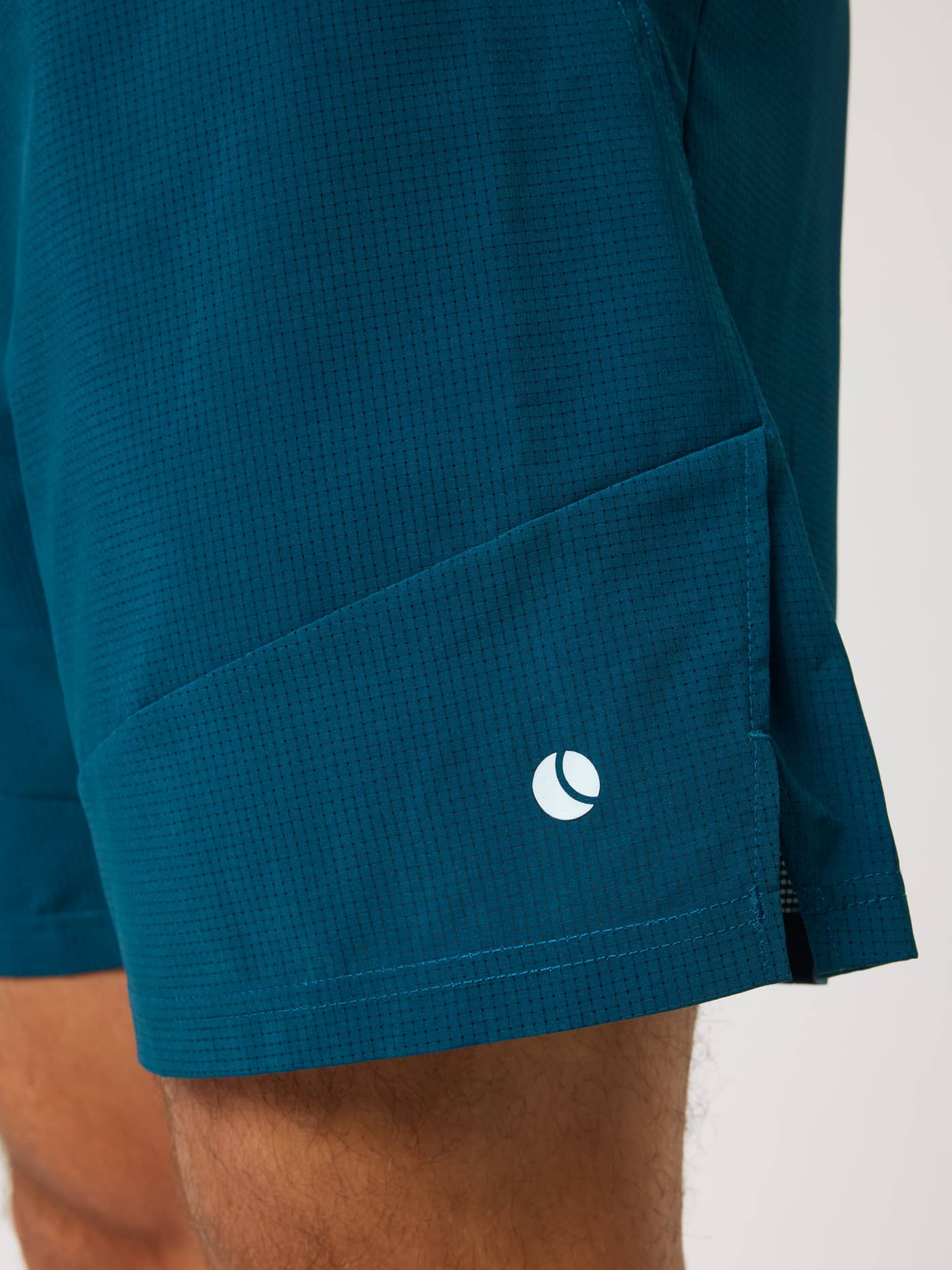 Ace Pro Shorts 7 Inch in Reflecting Pond (Green) for tennis, featuring perforated fabric and a white tennis ball logo. - Image 4