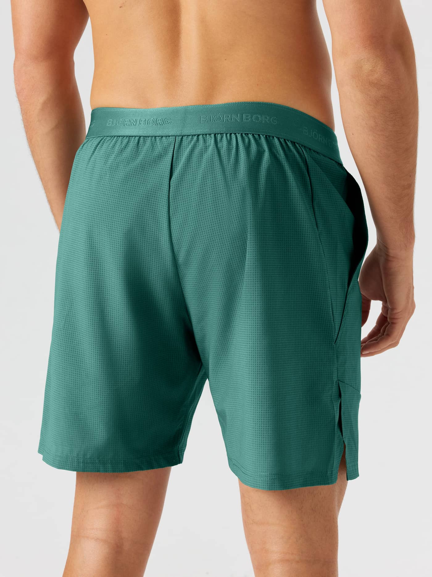 Back view of Ace Pro Shorts 7 Inch in Mallard Green (Green) with a tonal logo waistband and side slits for tennis training. - Image 2