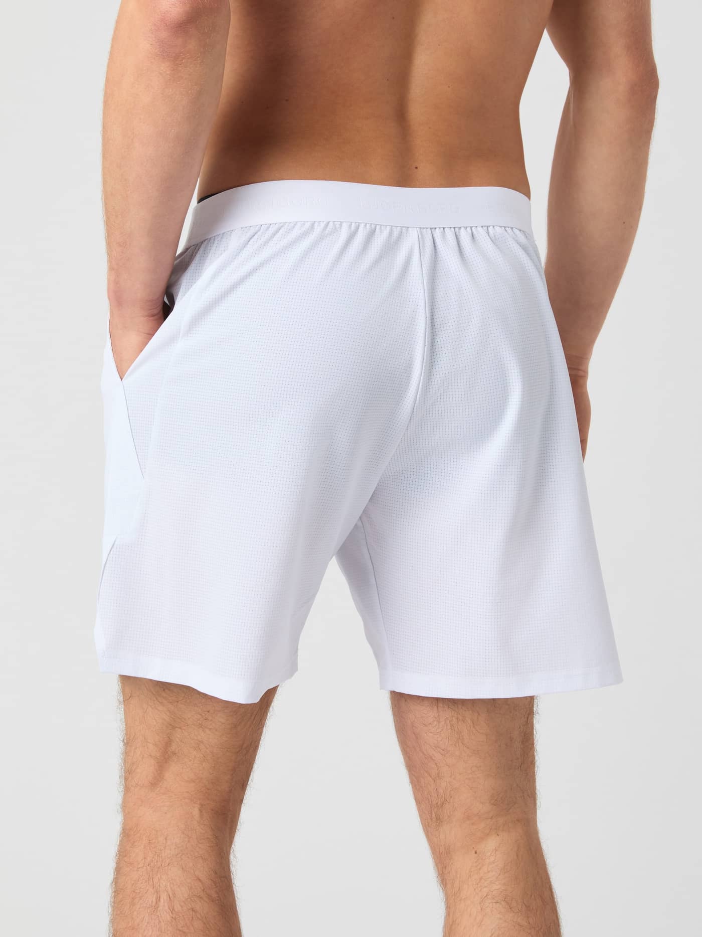 Back view of a man wearing the Björn Borg Ace Pro Shorts 7 Inch in Brilliant White (White) for tennis performance. - Image 3