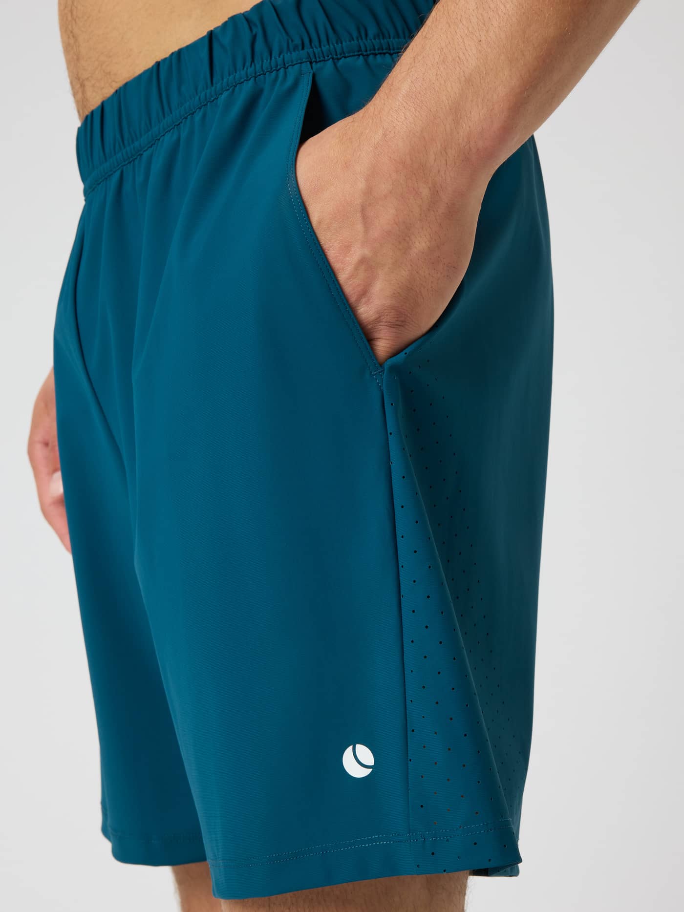 Side view of Ace Sports Shorts 8 Inch in Reflecting Pond (Green) with a white tennis logo and breathable perforated panels. - Image 4