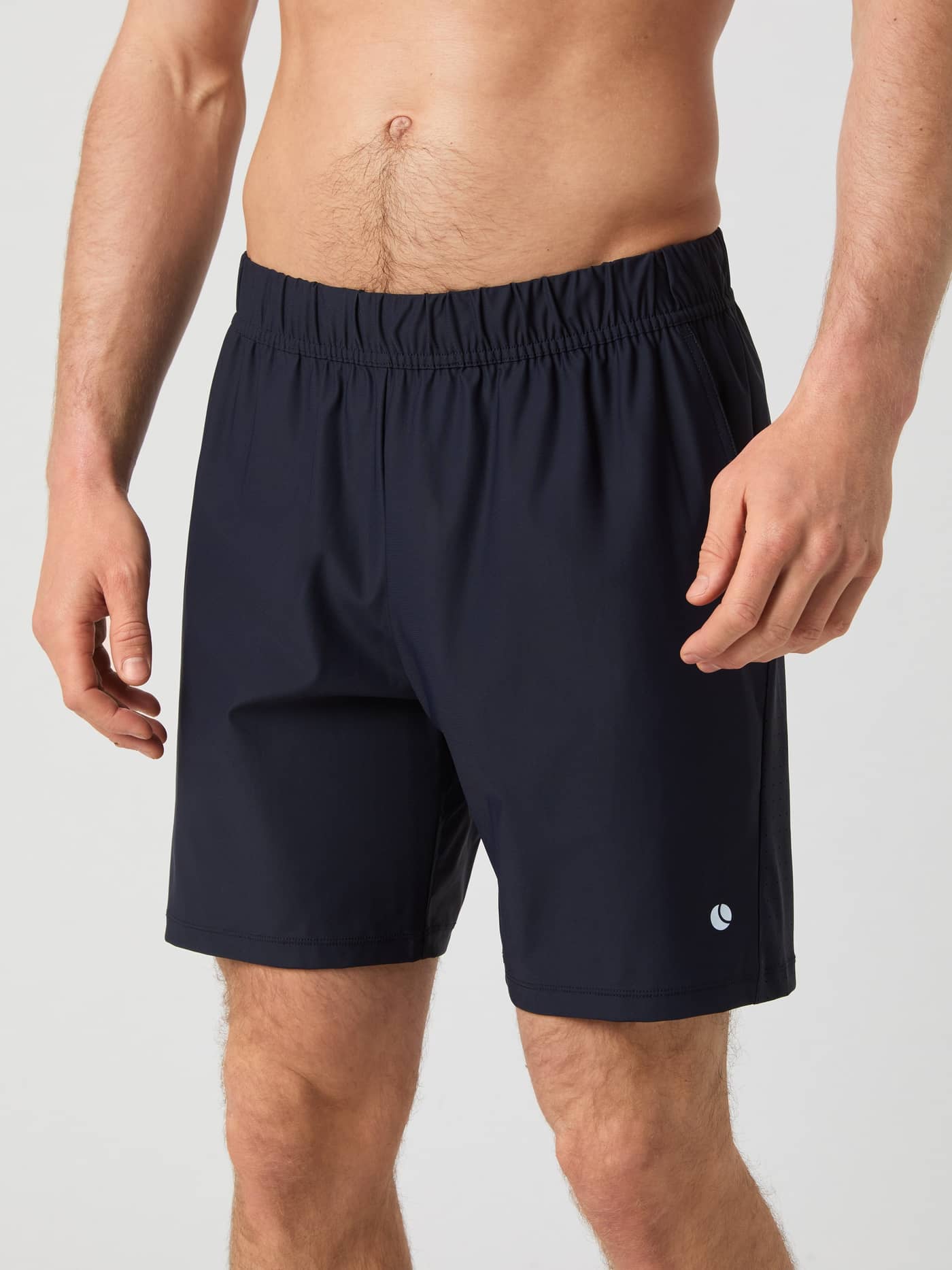 Close-up front view of a man wearing the navy Björn Borg Ace Sports 8" Shorts, highlighting the elastic waistband and fit. - Image 1