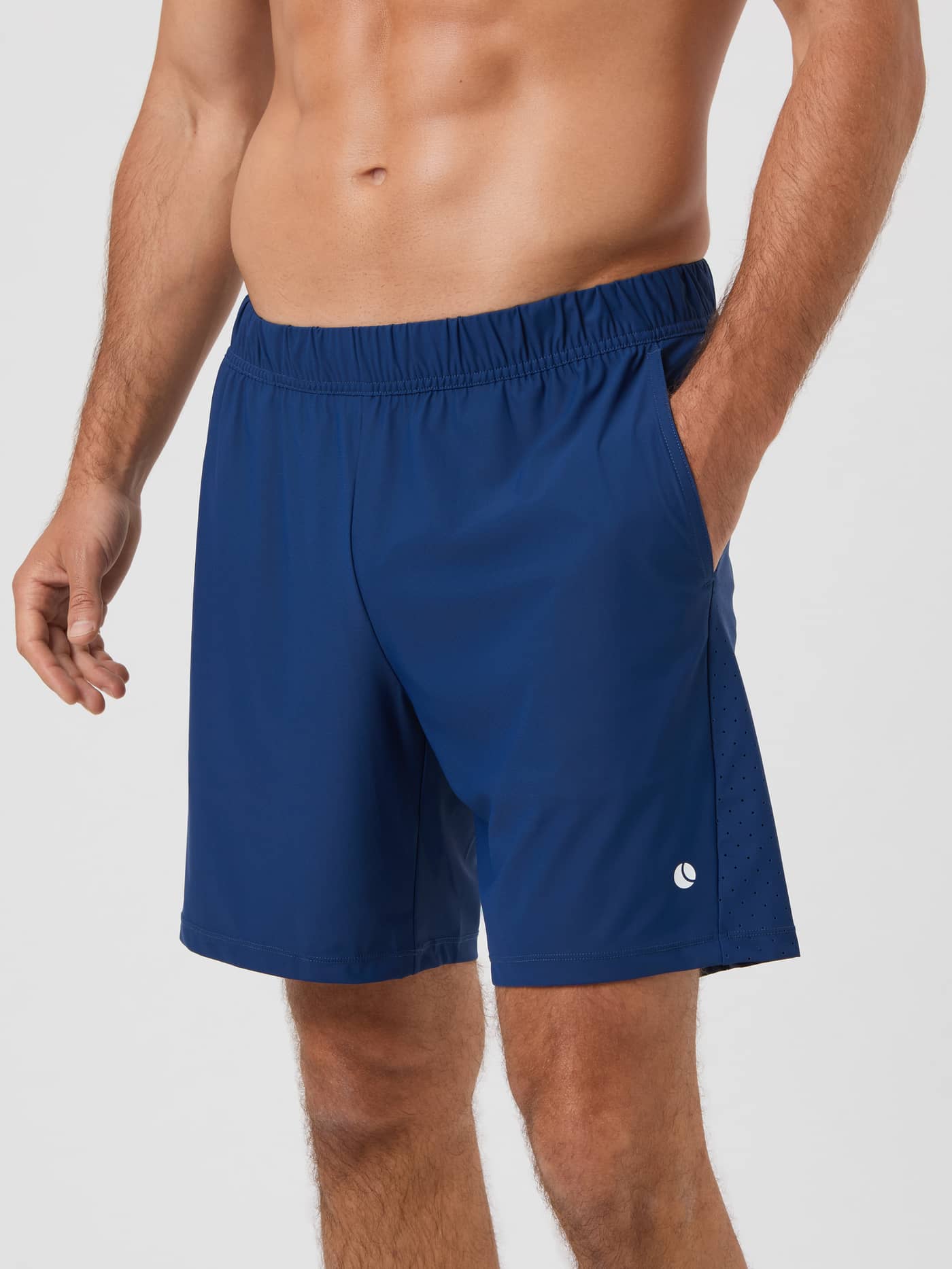 Side view of a model wearing the Estate Blue Björn Borg Ace Sports 8-inch Shorts with a hand in the pocket. - Image 1
