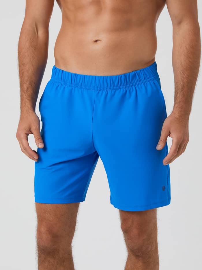 Front view of a model wearing the Björn Borg Ace Sports 8" Shorts in Electric Blue Lemonade.