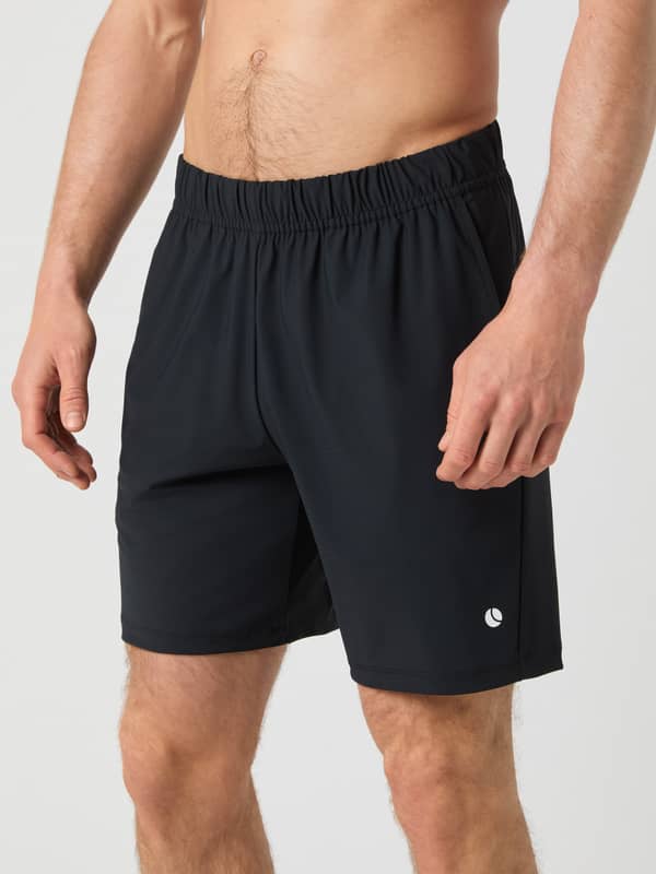 Side view of a man wearing the black Björn Borg Ace Sports 8-inch Shorts.
