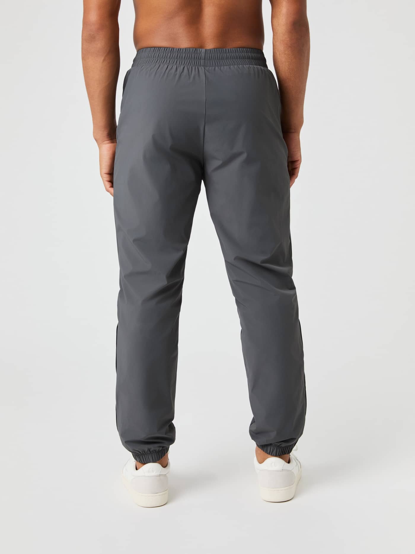 Back view of a man wearing the Björn Borg Ace Track Pants in Asphalt (Grey), offering a functional fit for tennis. - Image 3