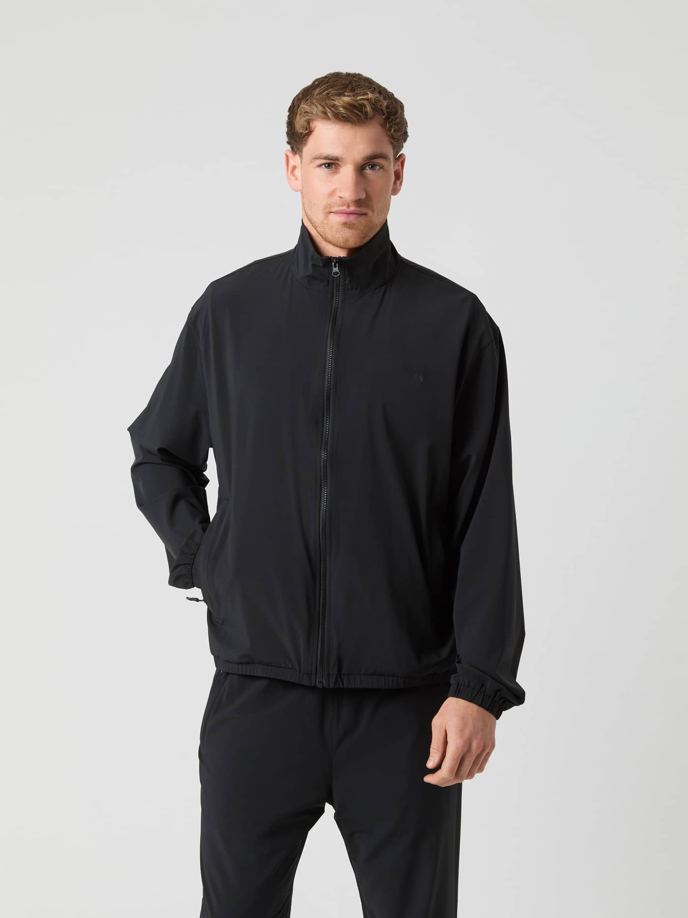 Front view of a man wearing the oversized Björn Borg Ace Track Jacket in Black Beauty (Black) for tennis. - Image 1