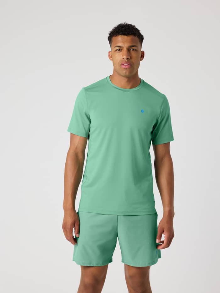 Front view of a man wearing the Malachite Green (Green) Ace Mesh Panel T-Shirt, combining tennis style and function.