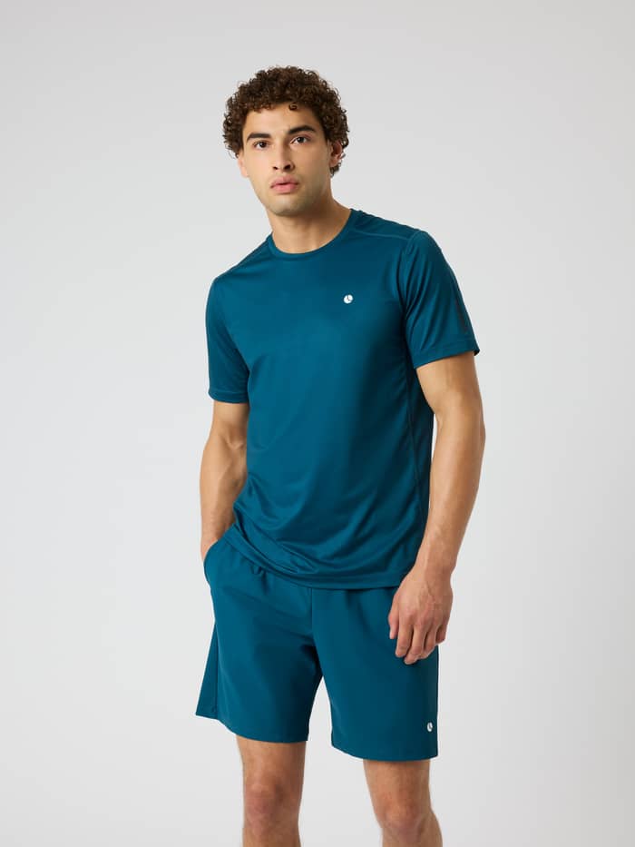 Front view of a model wearing the Ace Mesh Panel T-Shirt in Reflecting Pond (Blue) for tennis and padel.