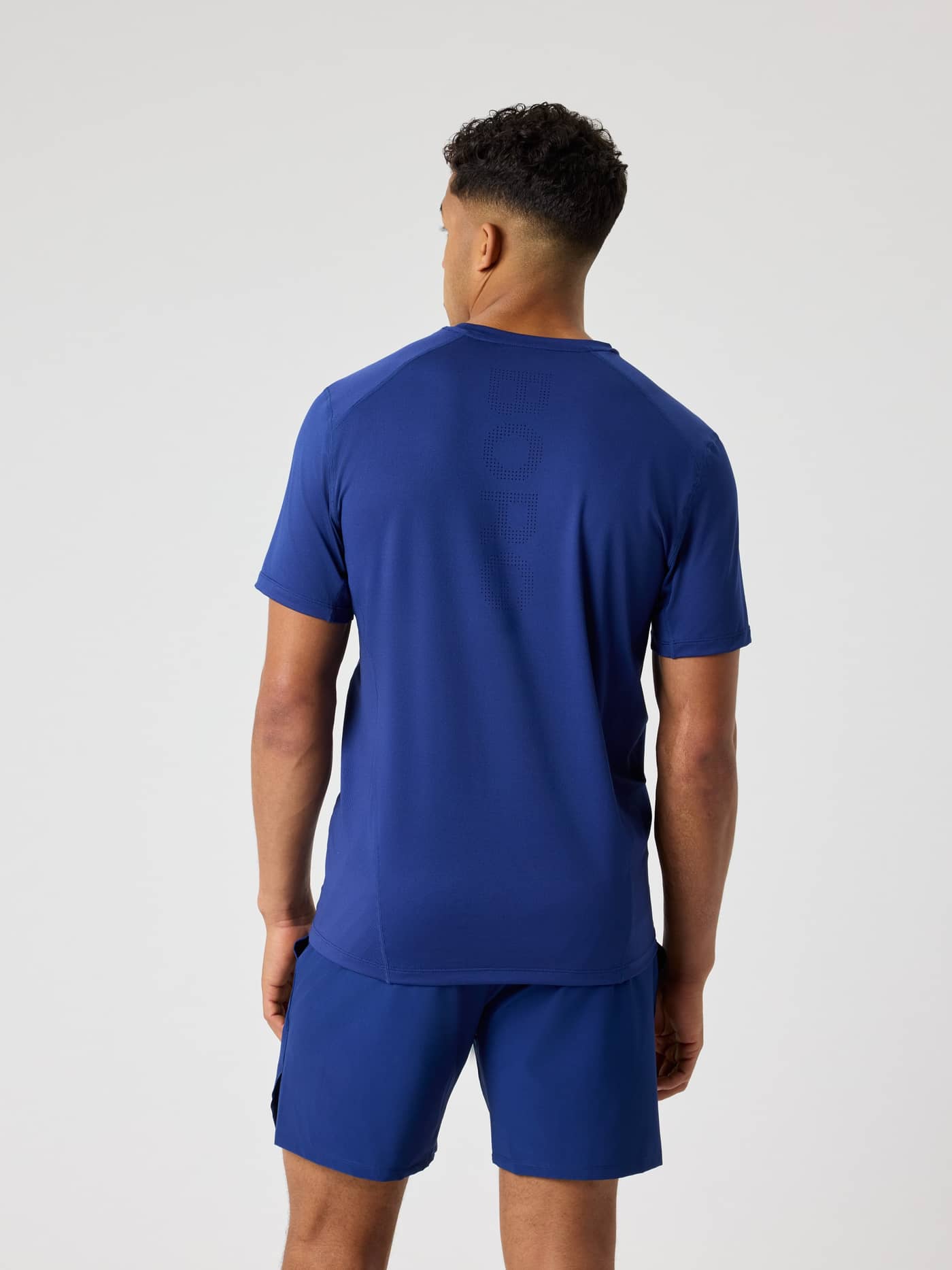 Ace Mesh Panel T-Shirt i Blue Depths (Blå) set bagfra med meshpaneler til performance på tennisbanen. - Image 2