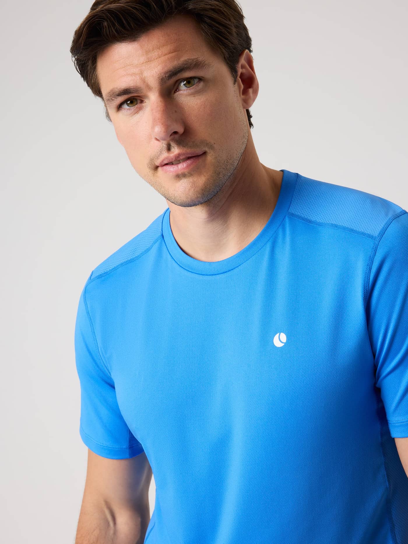 Front close-up of a man wearing the Ace Mesh Panel T-Shirt in Palace Blue (Blue) for breathable tennis performance. - Image 5