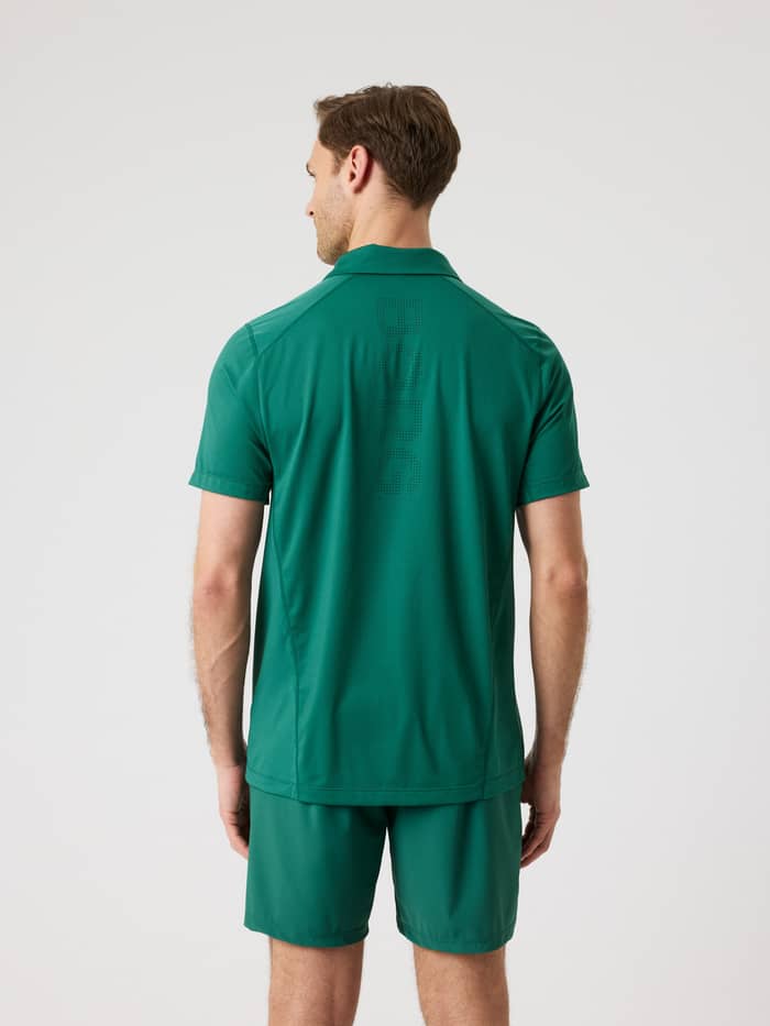 Back view of a man wearing the Ace Mesh Panel Polo Shirt in Posy Green (Green) with a perforated Borg logo for tennis. - Image 3
