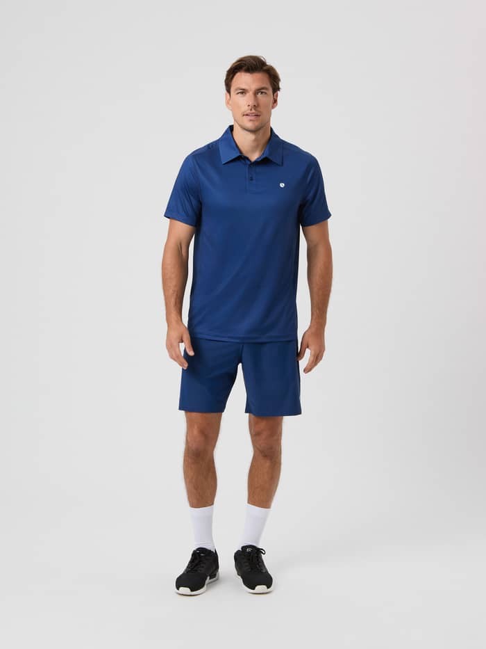 Full-body front view of a man wearing the Björn Borg Ace Mesh Panel Polo Shirt in Estate Blue (Blue) for tennis. - Image 4