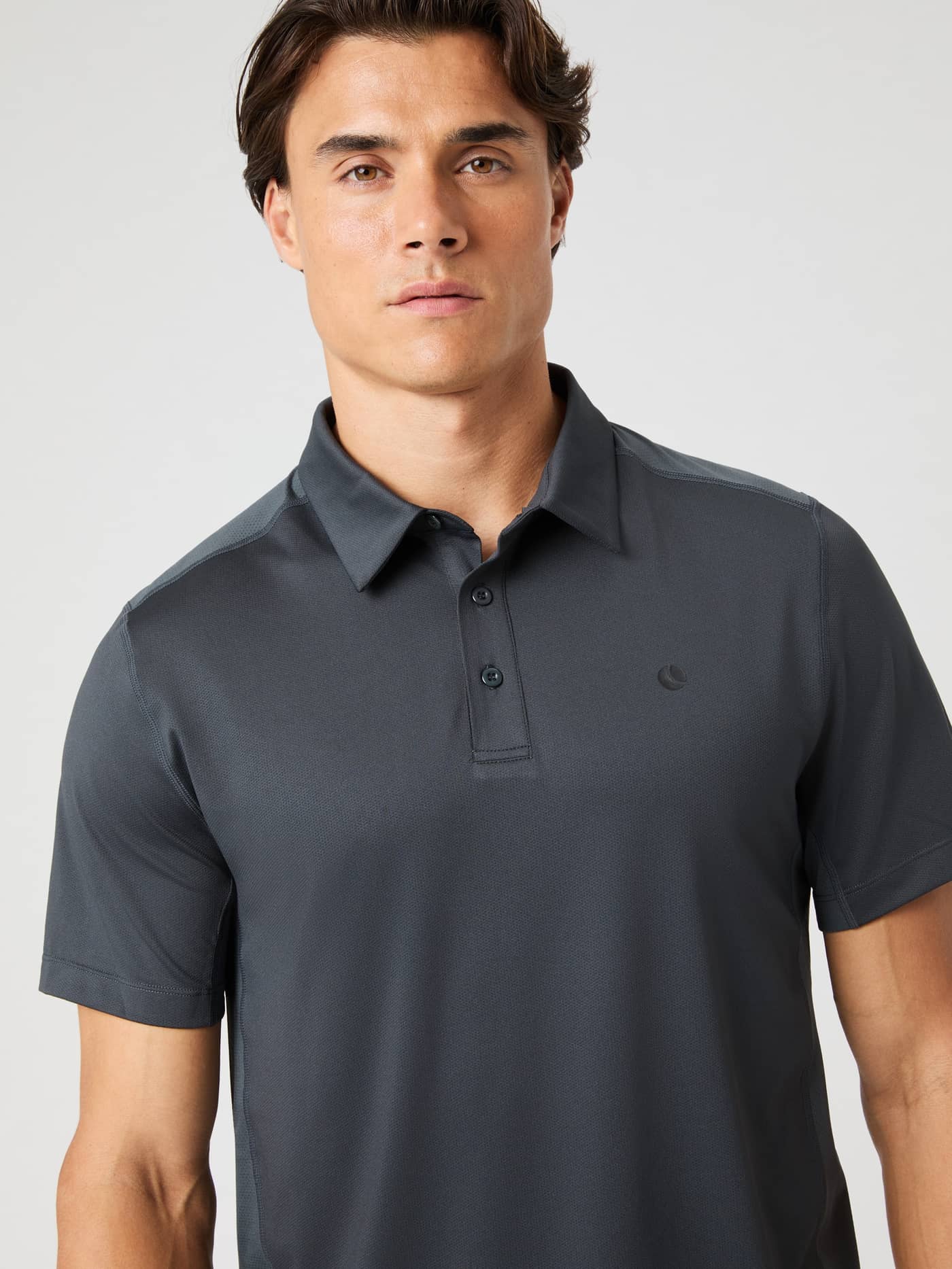 Front view of a man wearing the Björn Borg Ace Mesh Panel Polo Shirt in Asphalt (Grey), a functional tennis style. - Image 2