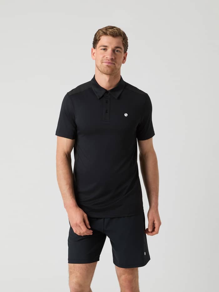Front view of a man wearing the Ace Mesh Panel Polo Shirt in Black Beauty (Black) for performance tennis.