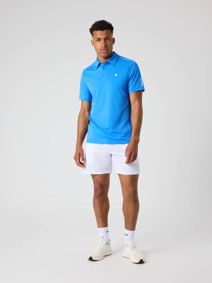 Full-body front view of a man in the Björn Borg Ace Mesh Panel Polo Shirt in Palace Blue (Blue) for performance tennis. - Image 3