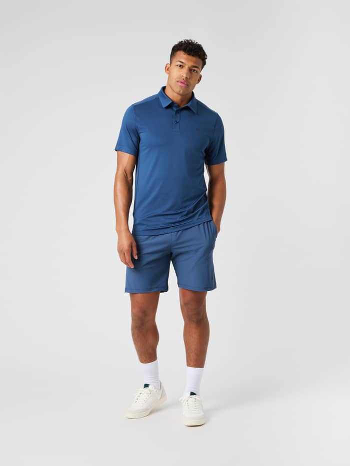 Full-body front view of a man in the Ace Mesh Panel Polo Shirt in Sargasso Sea (Blue) for breathable tennis performance. - Image 3
