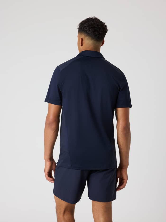 Back view of a model wearing the Björn Borg Ace Mesh Panel Polo Shirt in Night sky (Navy), ideal for tennis. - Image 2