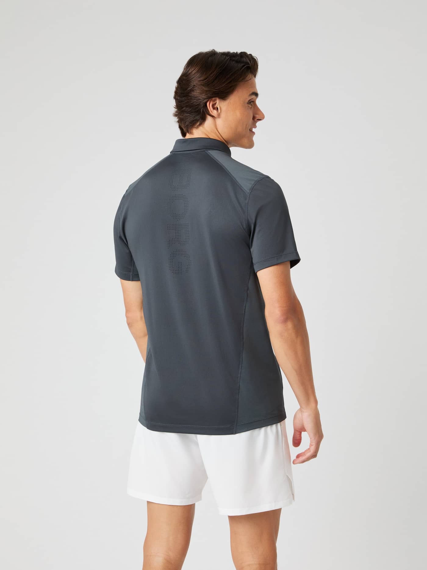 Back view of a man wearing the Björn Borg Ace Mesh Panel Polo Shirt in Asphalt (Grey) with a perforated logo for tennis. - Image 4