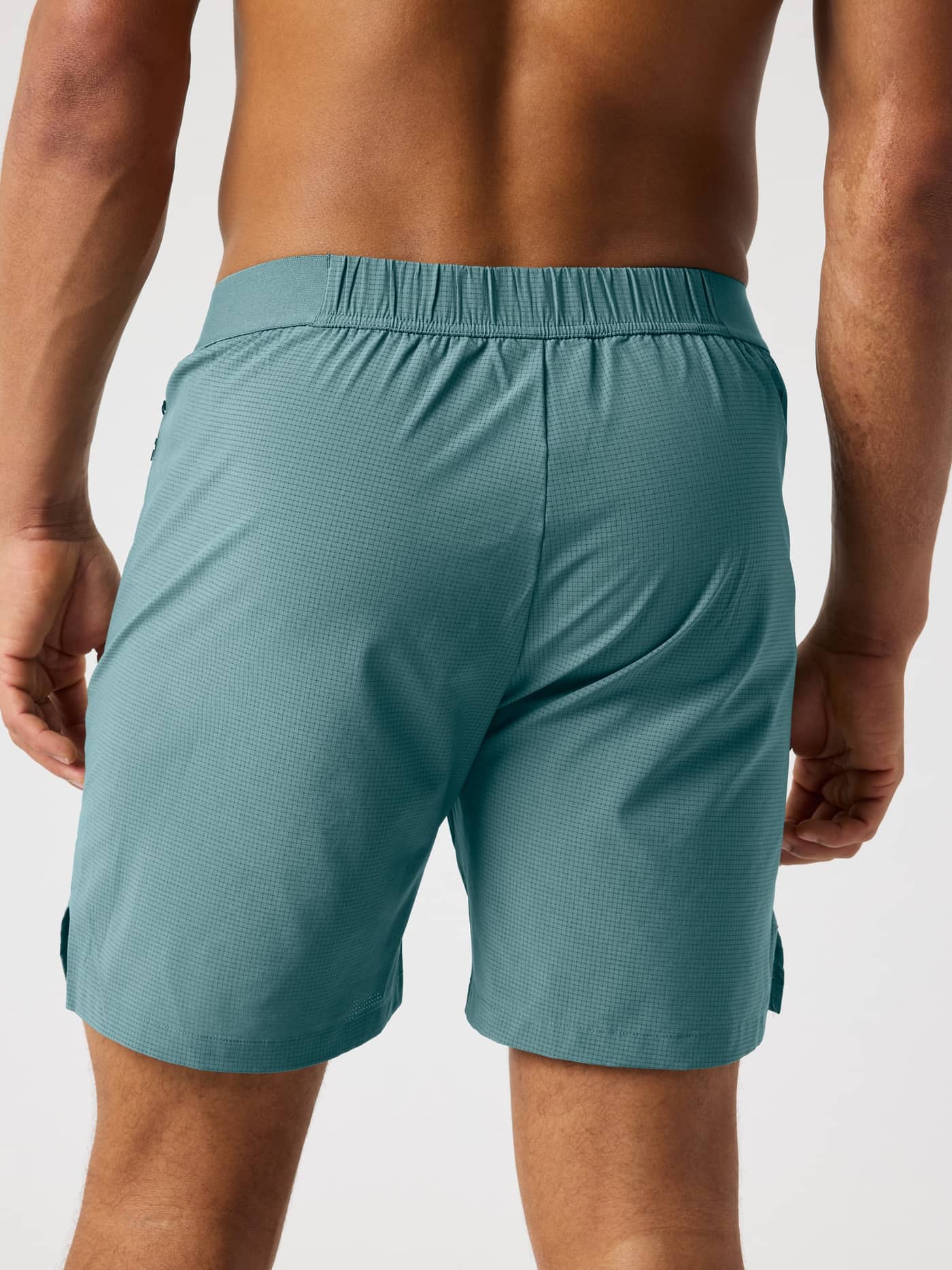 Back view of the Balsam Green (Green) Borg Zip Shorts 7 Inch, featuring a technical weave for training, running, and tennis. - Image 2