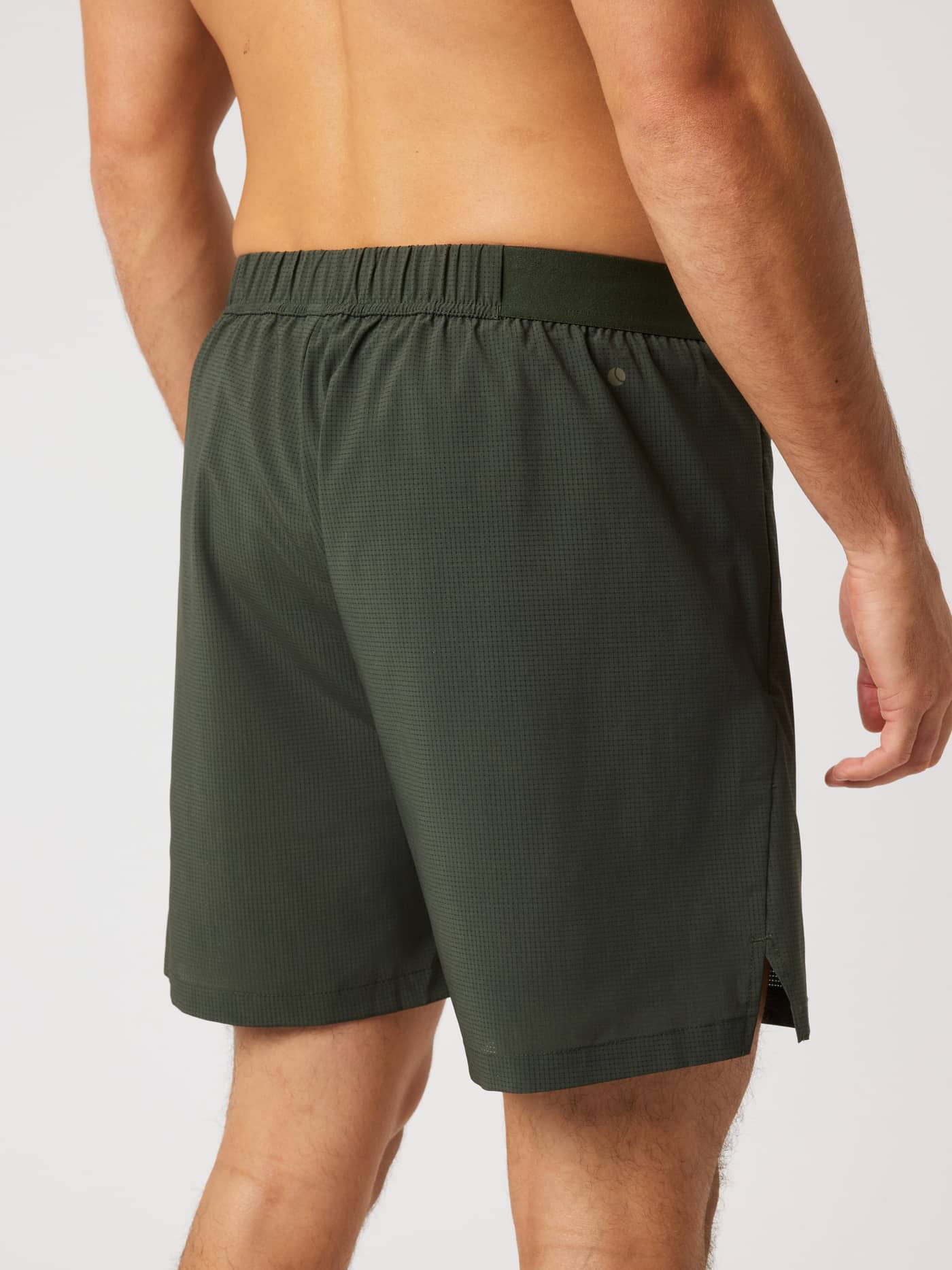 Back view of a man wearing Borg Zip Shorts 7 Inch in Rosin (Green) for training and running. - Image 2