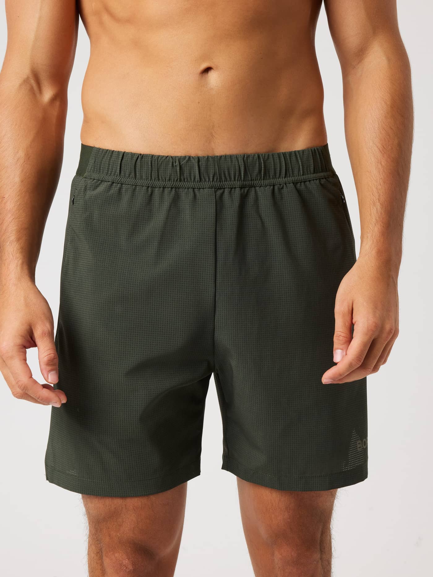Front view of the Borg Zip Shorts 7 Inch in Rosin (Green) for training, with perforated fabric and a tonal logo. - Image 1