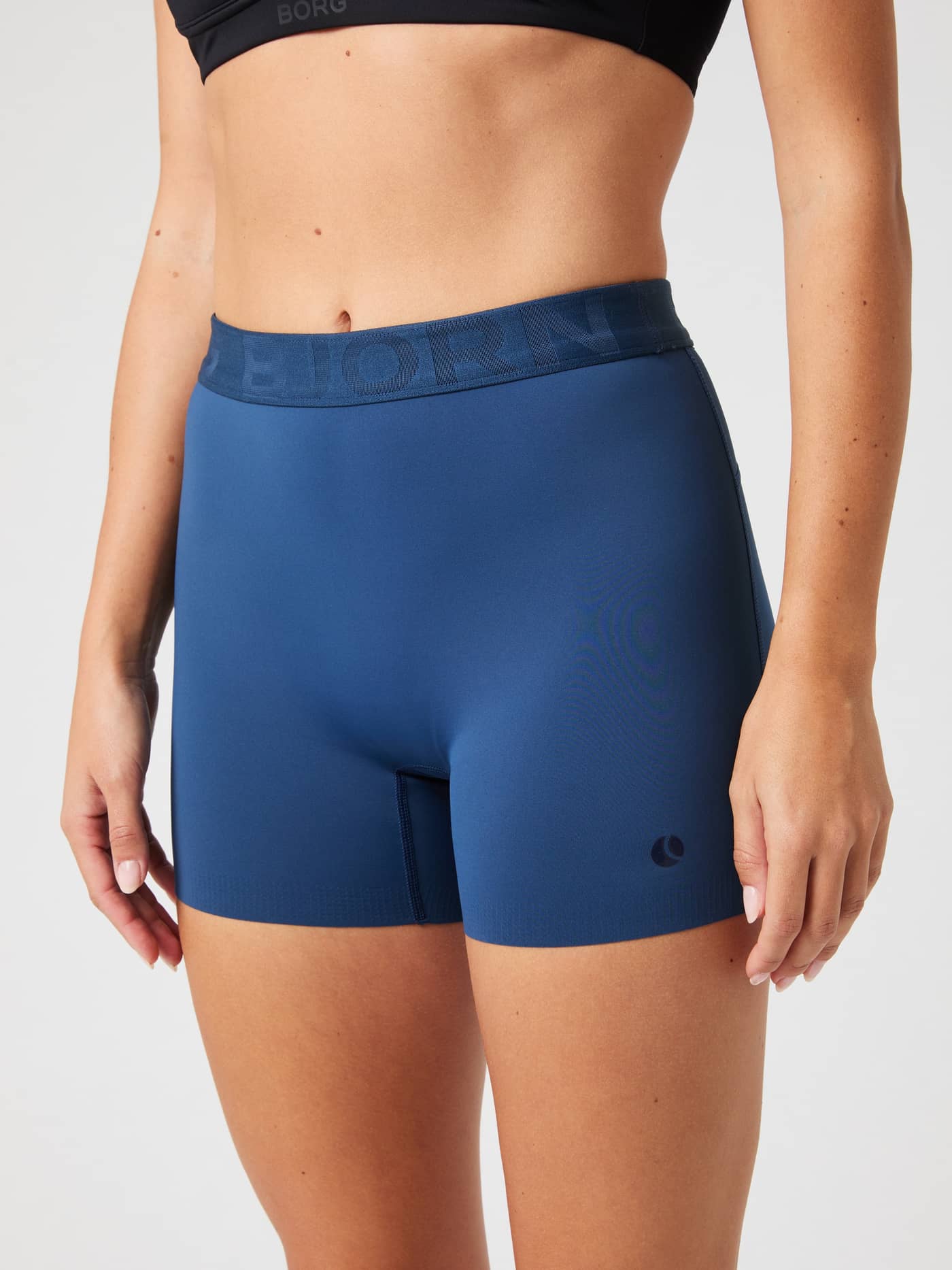 Front view of high-stretch Björn Borg Ace Short Shorts in Sargasso Sea (Blue) with blue logo and high-waisted tennis fit. - Image 1