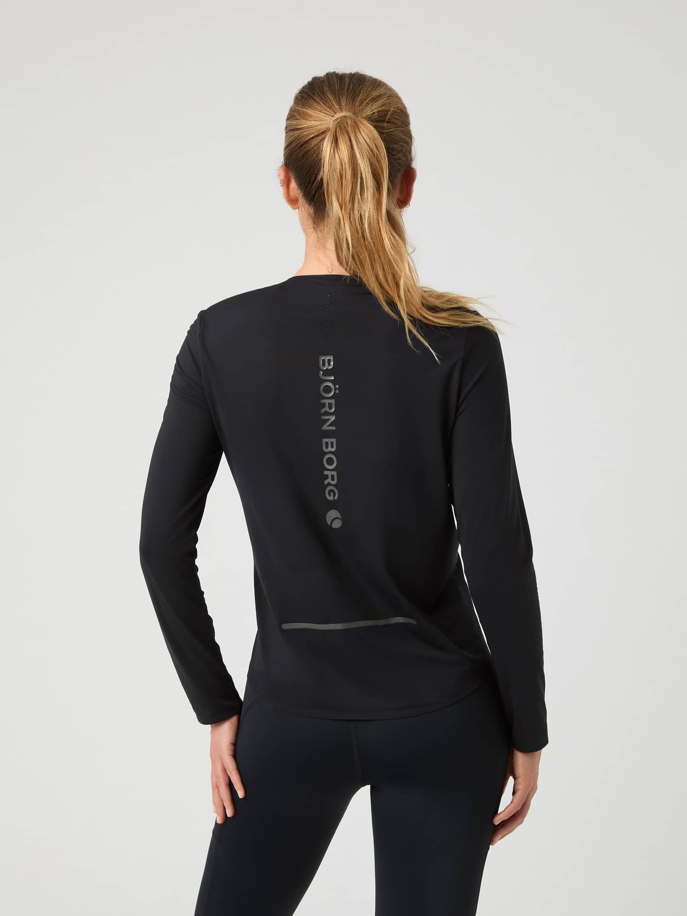 Back view of the Borg Running Feather Long Sleeve T-Shirt in Black Beauty (Black) with a vertical logo and laser-cut holes. - Image 2
