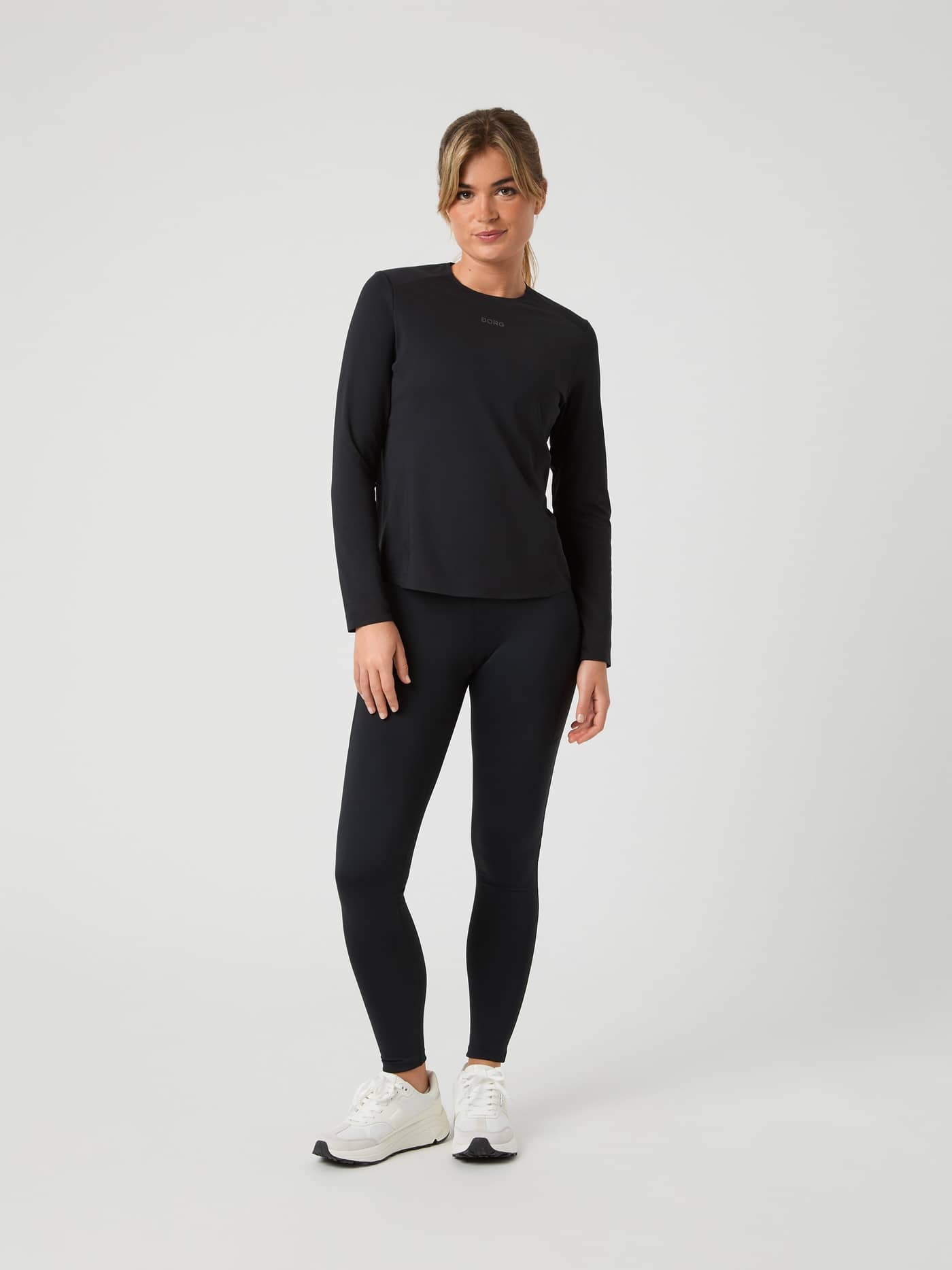 Full-body front view of a woman wearing the Björn Borg Running Feather Long Sleeve T-Shirt in Black Beauty (Black). - Image 3
