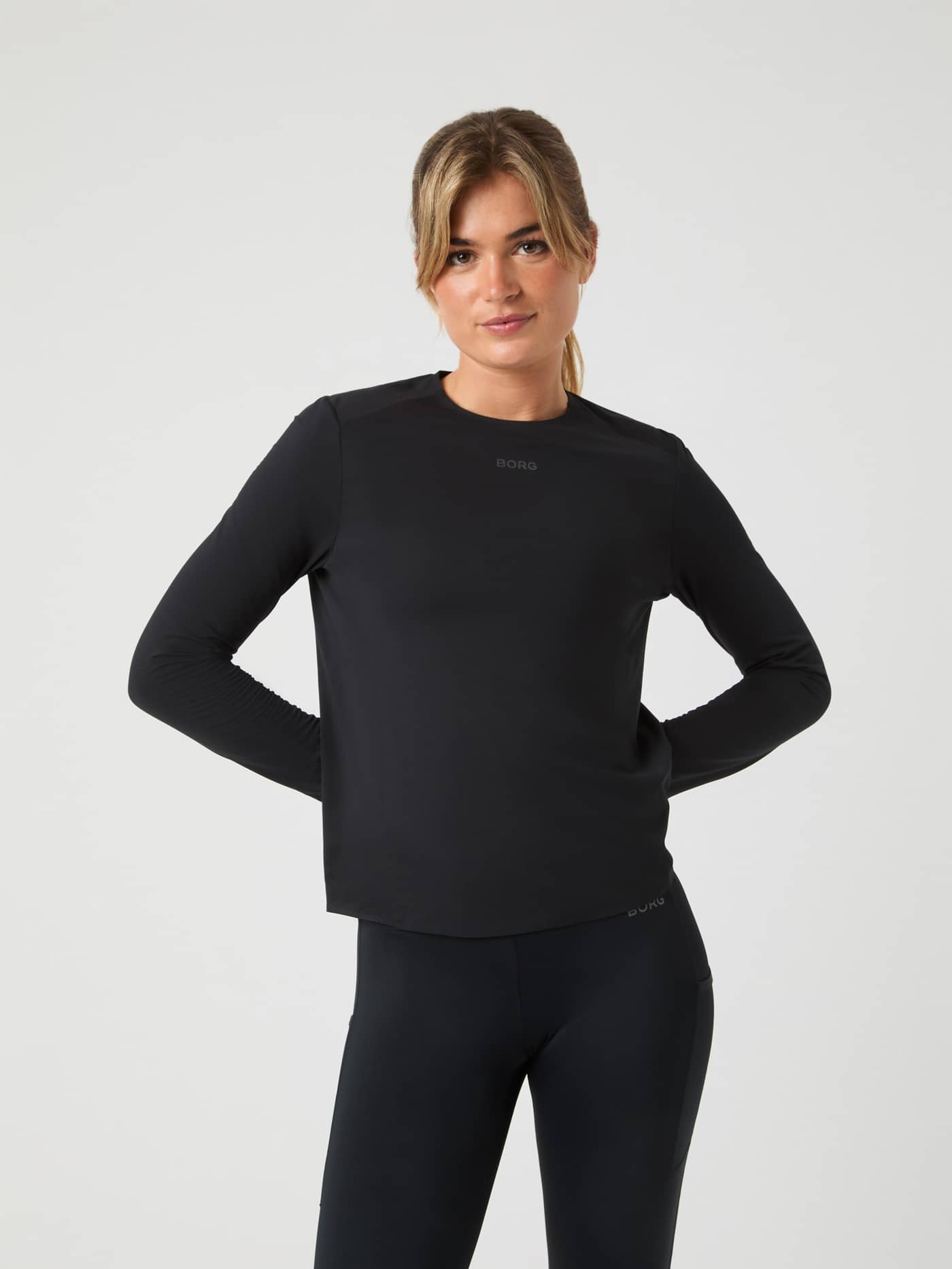 Front view of a model in the regular fit Borg Running Feather Long Sleeve T-Shirt in Black Beauty (Black) for performance. - Image 1