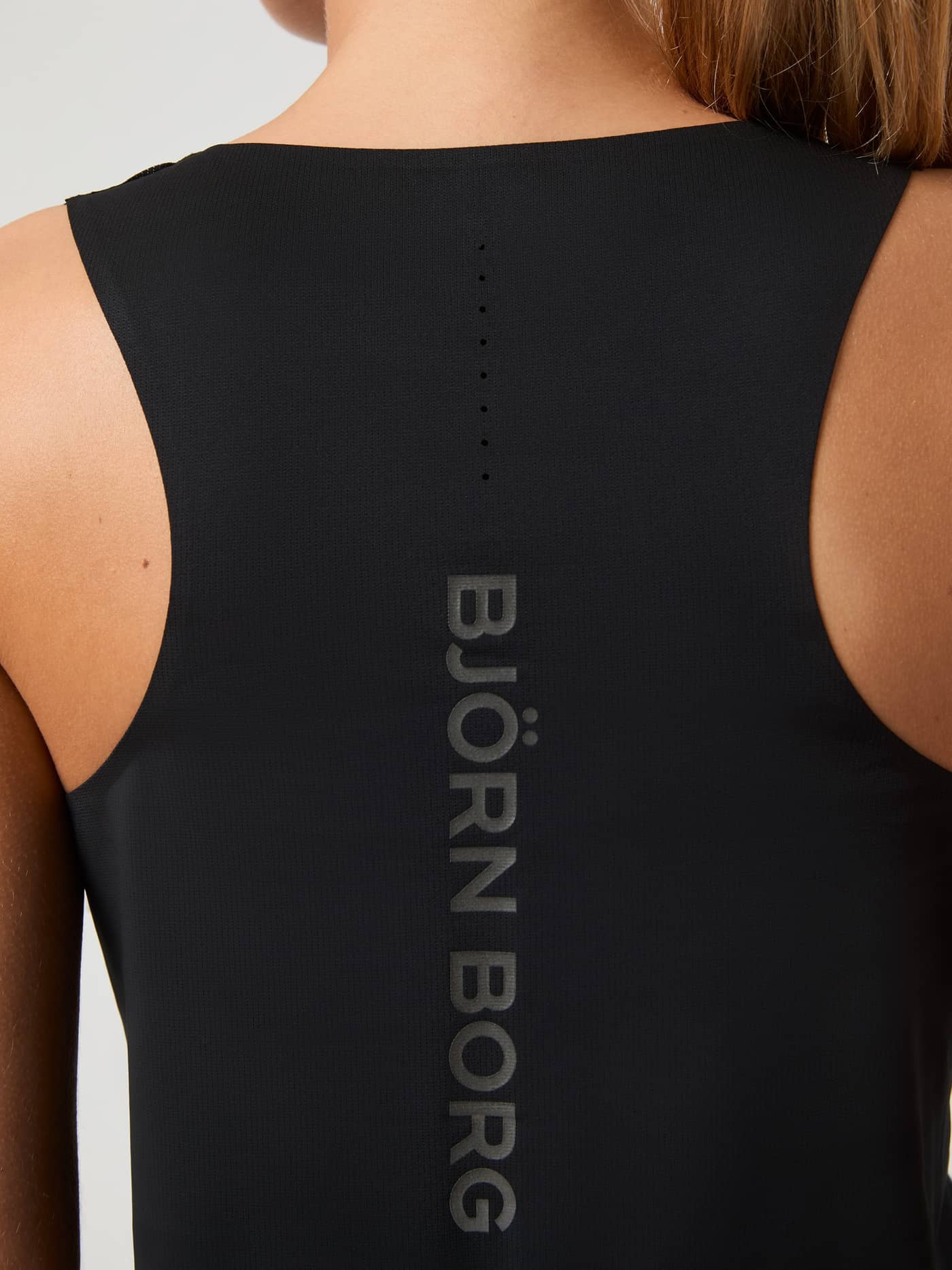Back view of the women's Borg Running Feather Tank in Black Beauty (Black) with a racerback fit and a tonal vertical logo. - Image 4