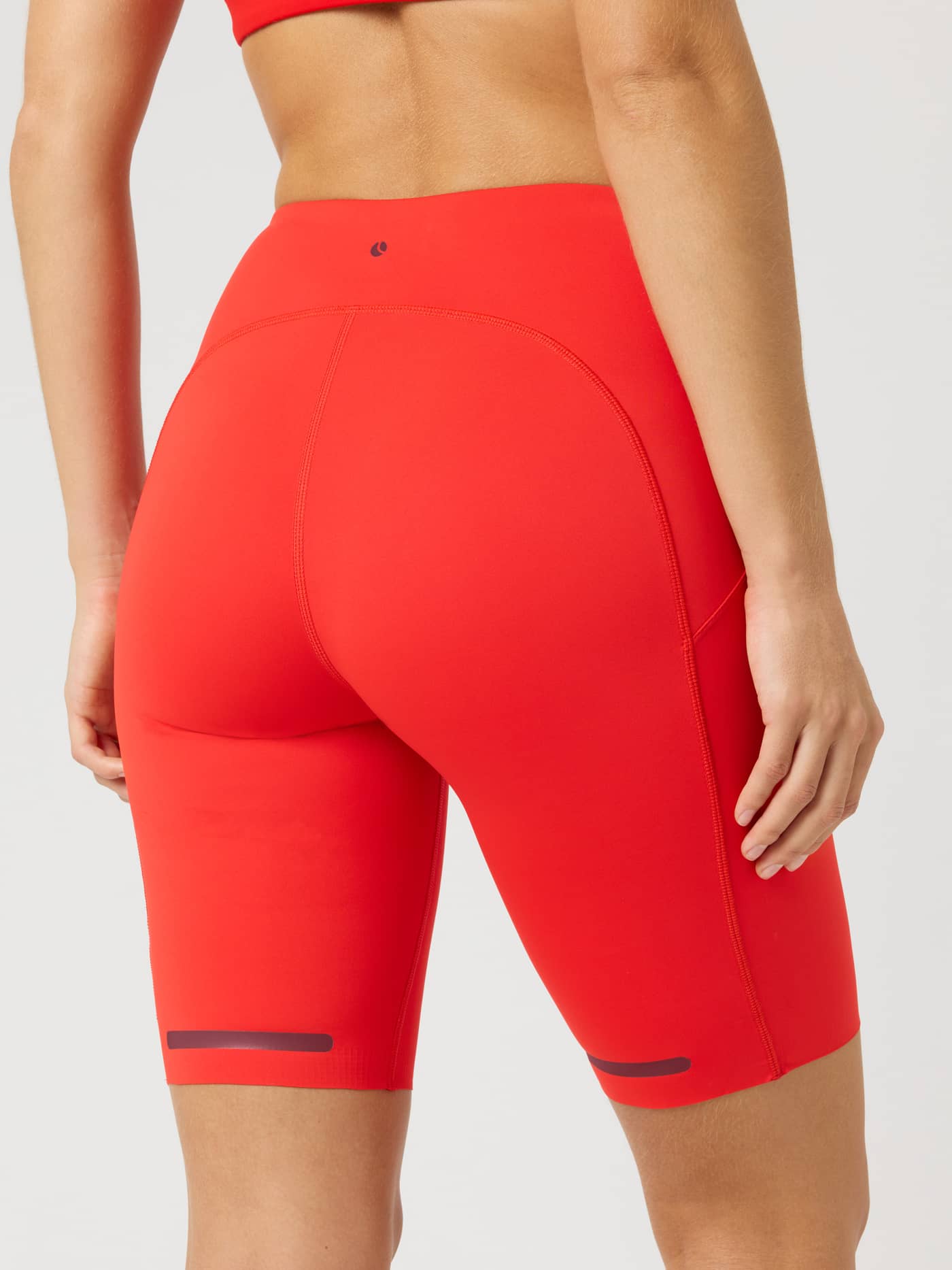 Back view of Borg Performance Short Tights in Flame Scarlet (Red) featuring side pockets and reflective strips for running. - Image 2